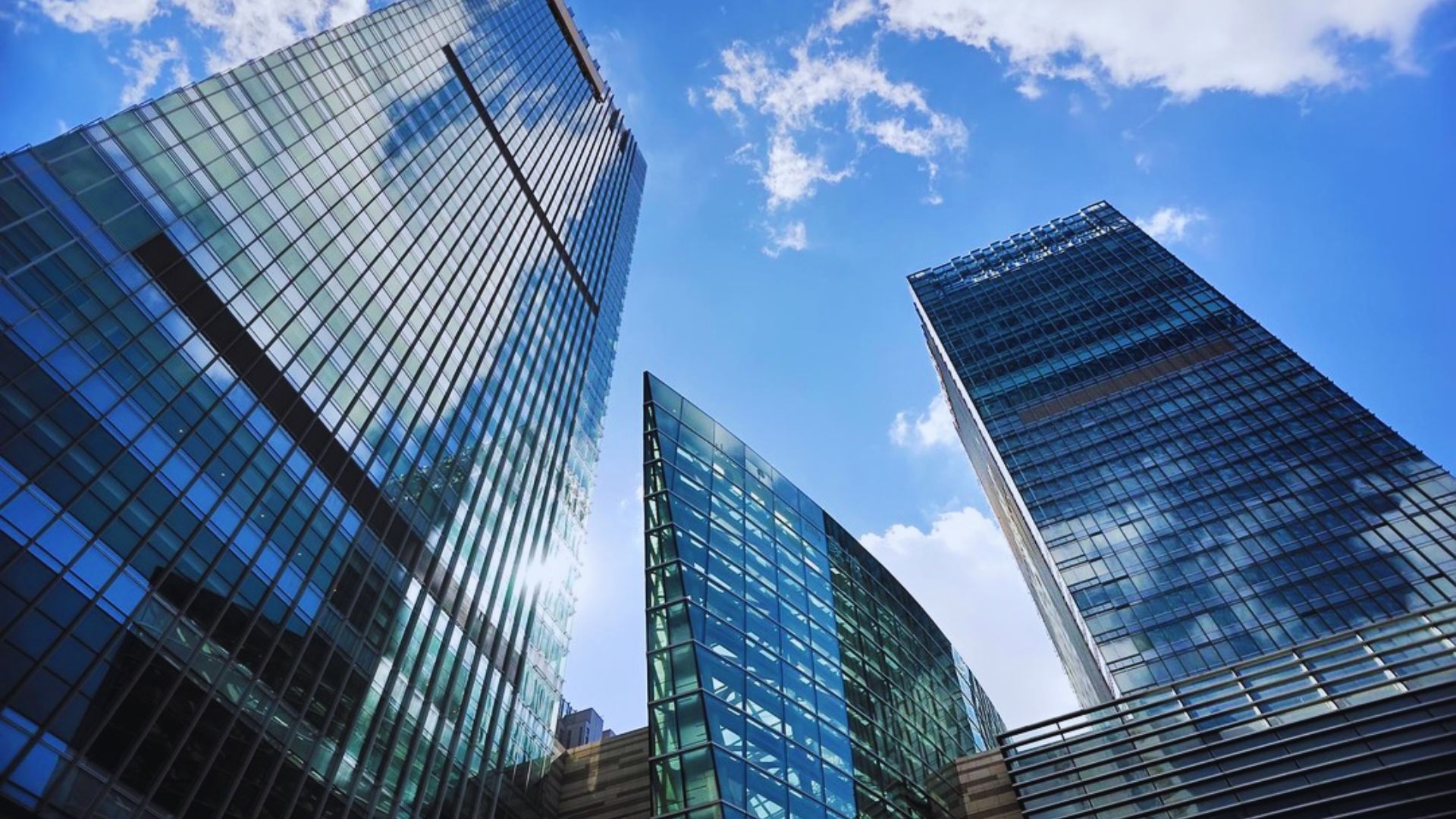 A view of London's skyline featuring modern skyscrapers against a clear blue sky.