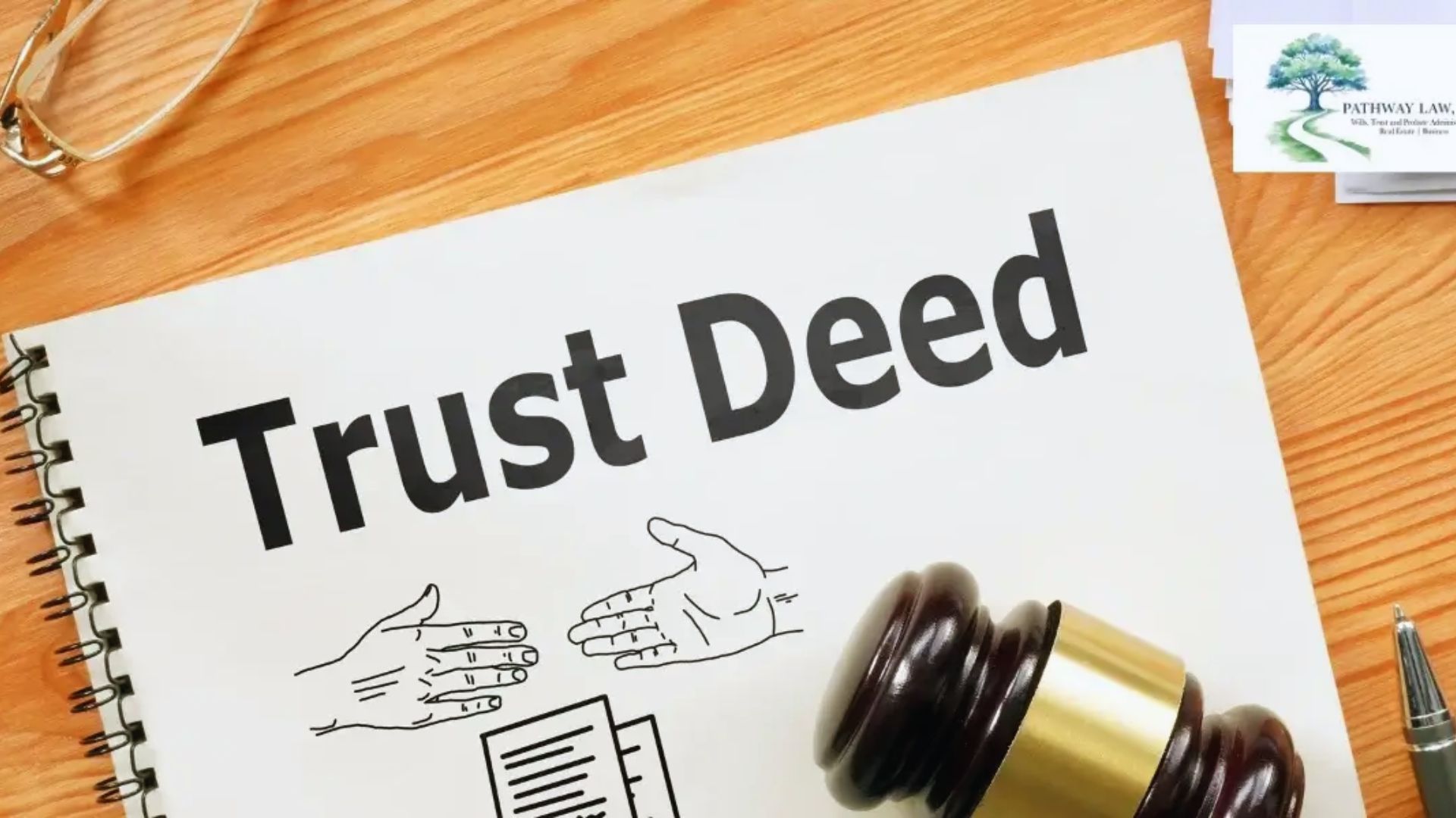 Trust deed document on a table beside a gavel, symbolizing legal authority and decision-making in a courtroom setting.