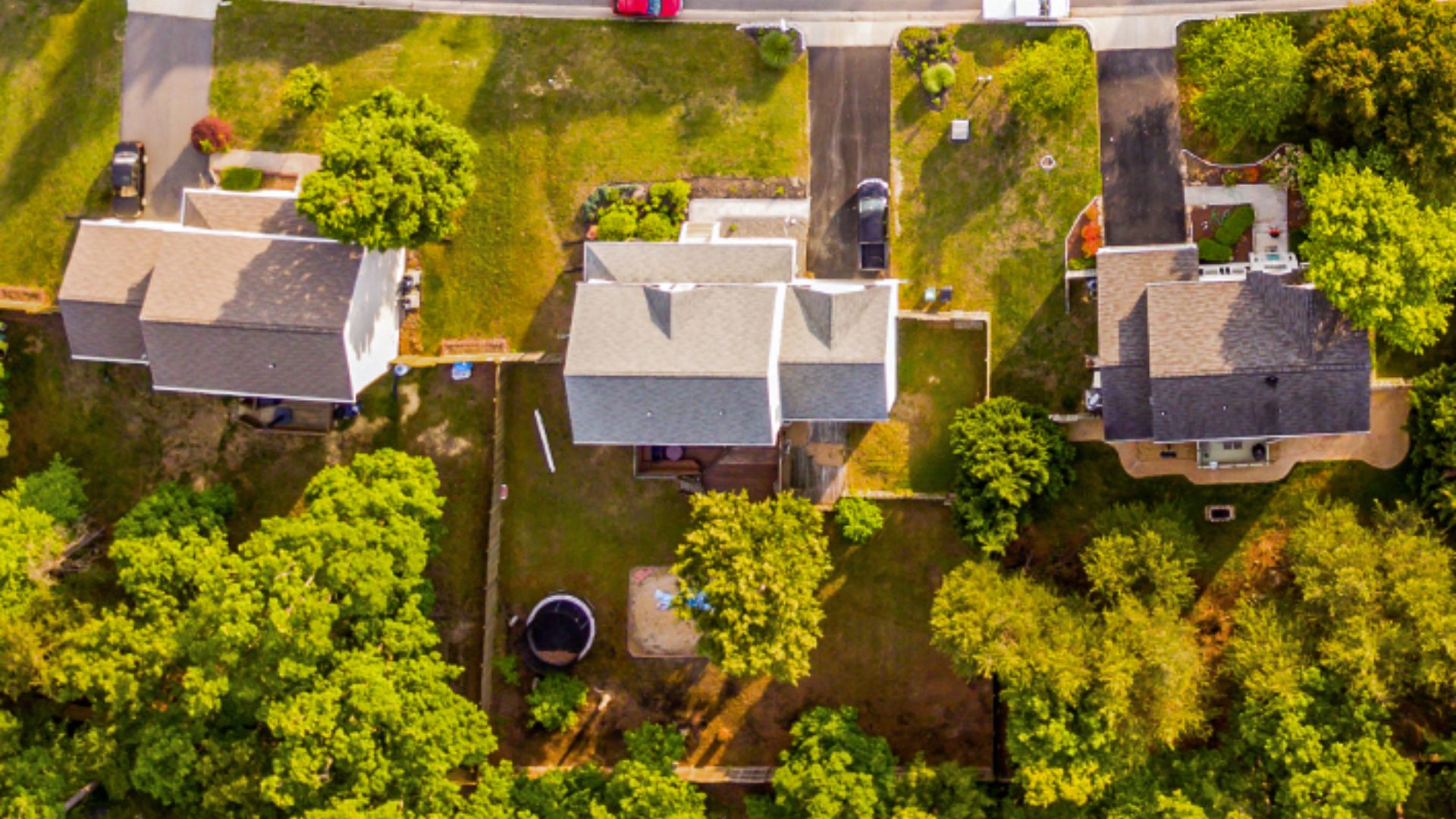 Aerial view of a neighborhood featuring houses and trees, showcasing the layout and greenery of the area.