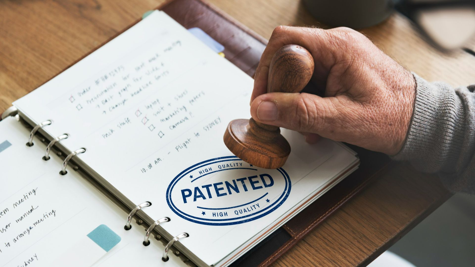 Patent office stamp embossed on a notebook, indicating official documentation or intellectual property registration.