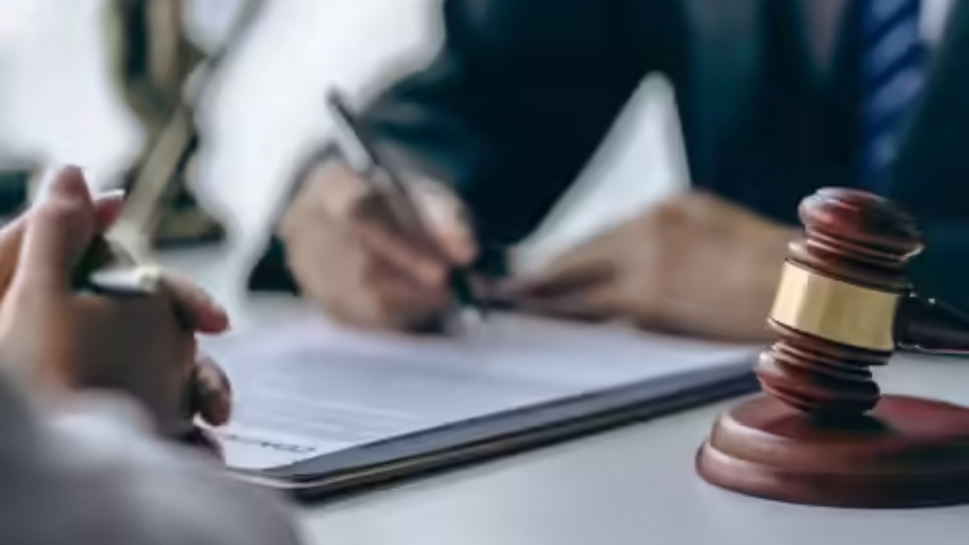 Lawyer and client engaged in a discussion during a meeting in a professional office setting.