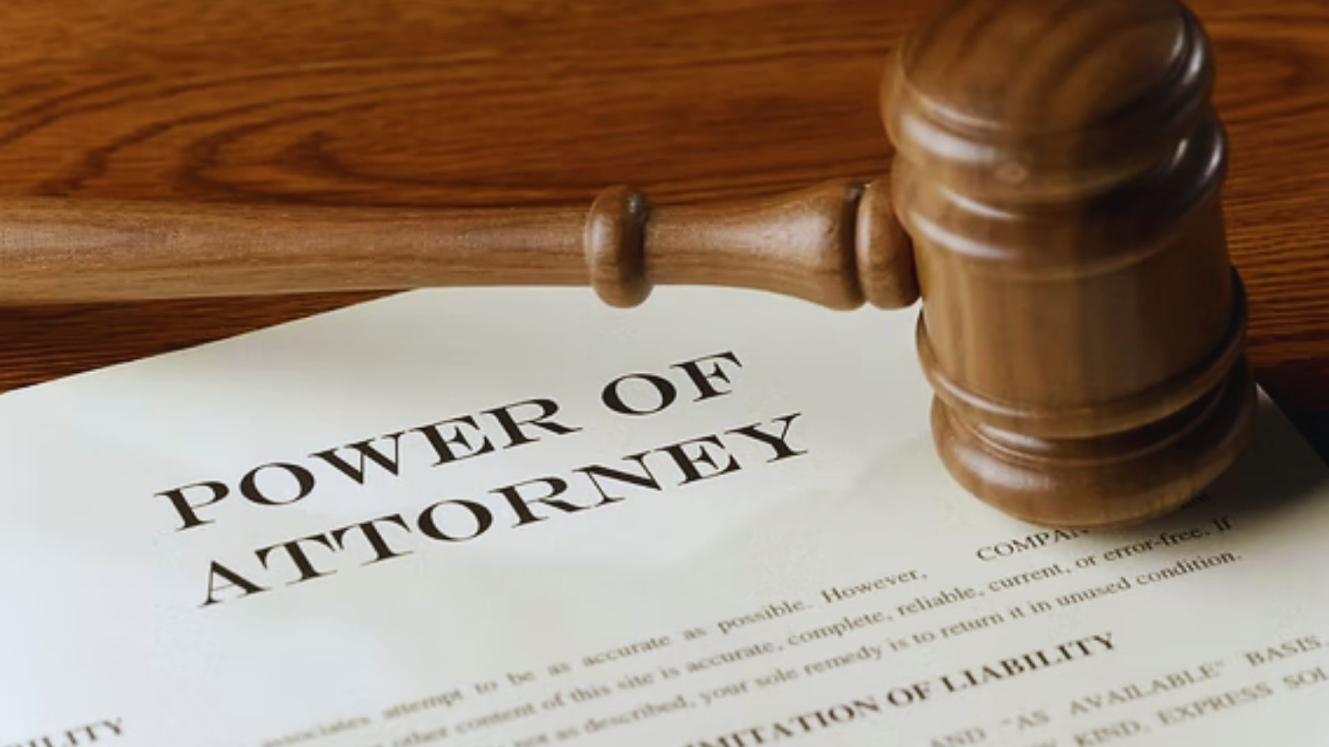Document titled "Power of Attorney" with legal text and signature lines, symbolizing authority and decision-making.
