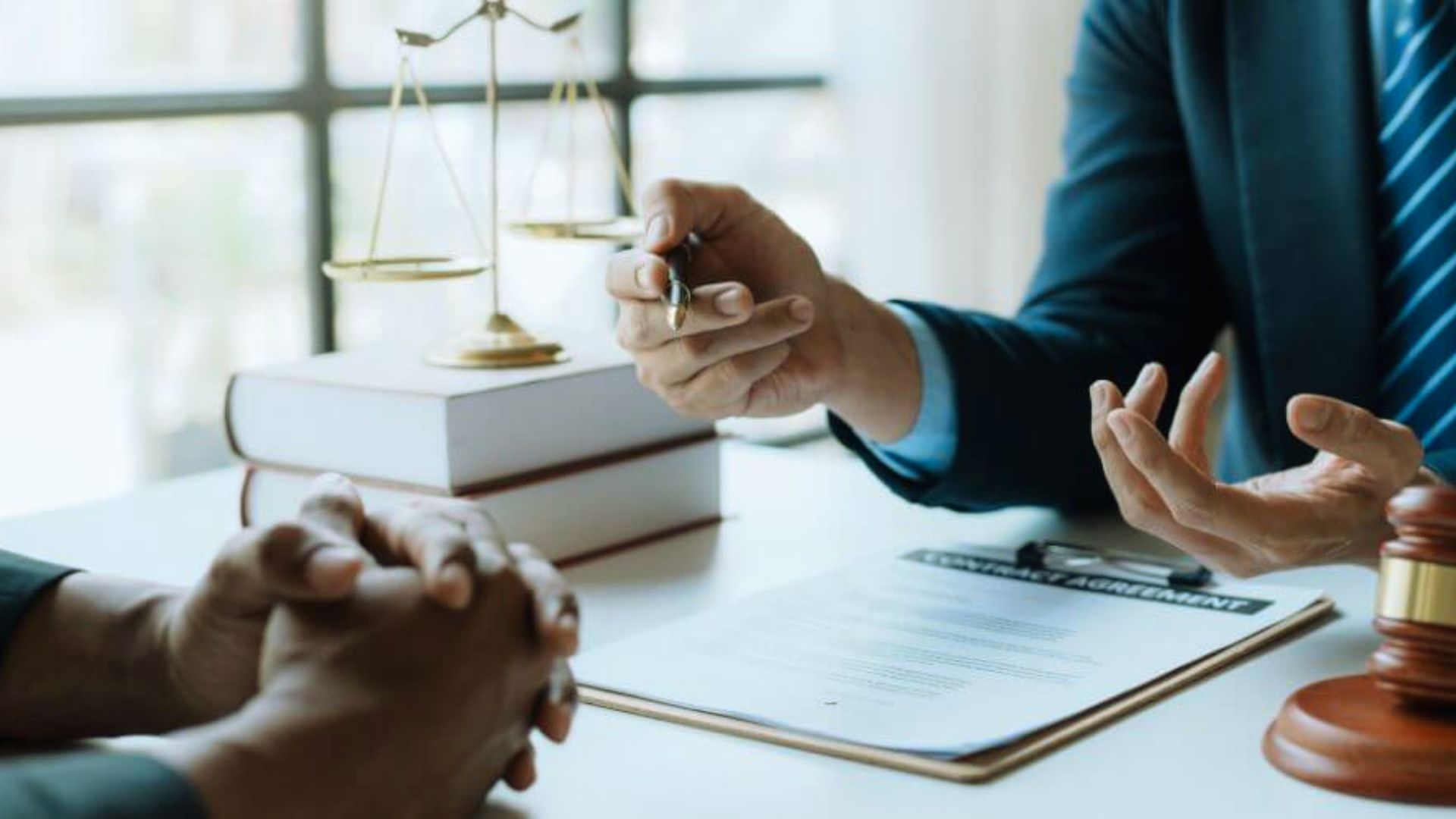 Lawyer and client engaged in a discussion during a meeting in a professional office setting.