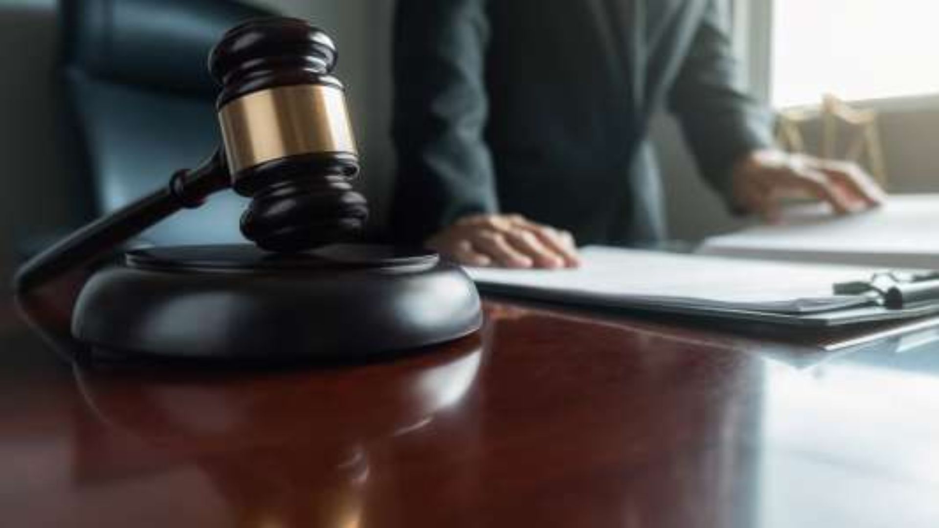 A judge's gavel rests on a wooden desk, symbolizing authority and the judicial process.