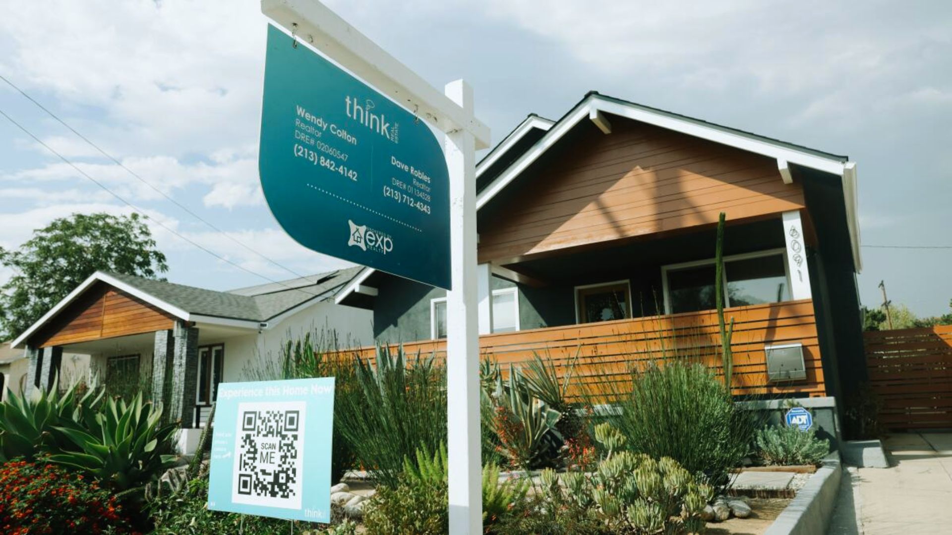 A real estate sign stands in front of a house in Los Angeles, California, dated June 30, 2018.