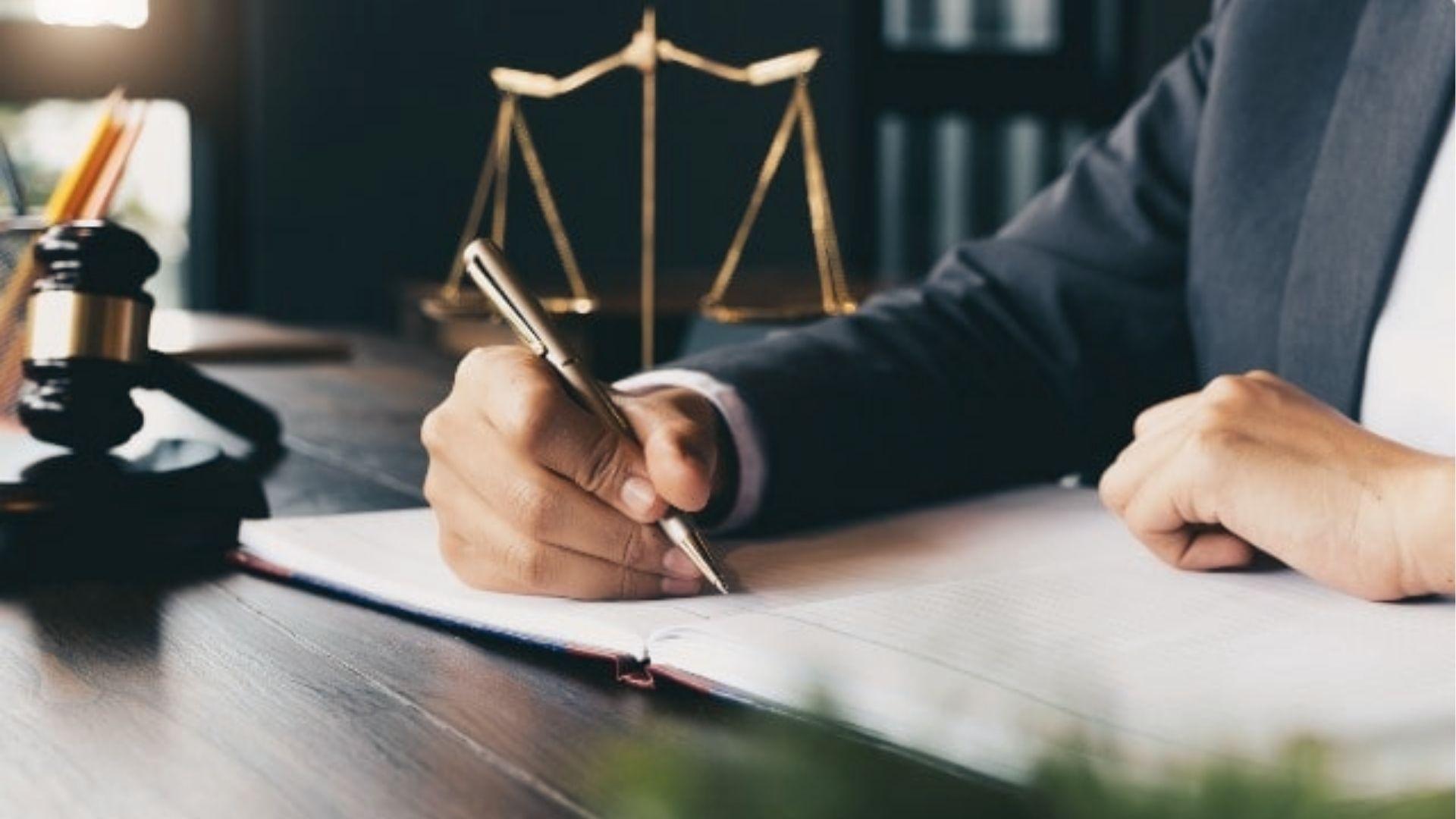Attorney drafts estate documents, explaining living trust vs will benefits for avoiding probate.