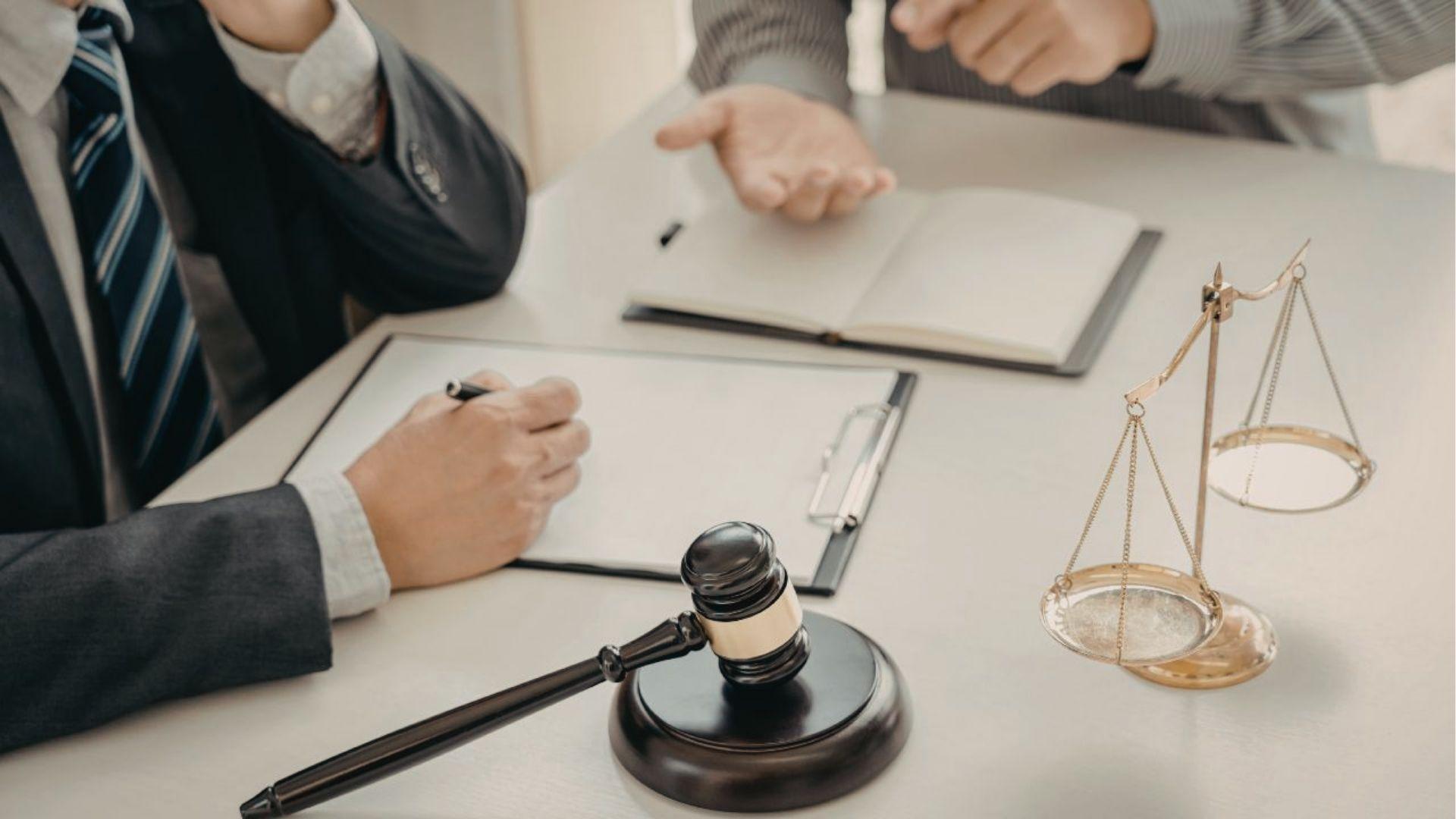 Attorneys discuss legal options with gavel and scales, reviewing Virginia squatters rights cases.