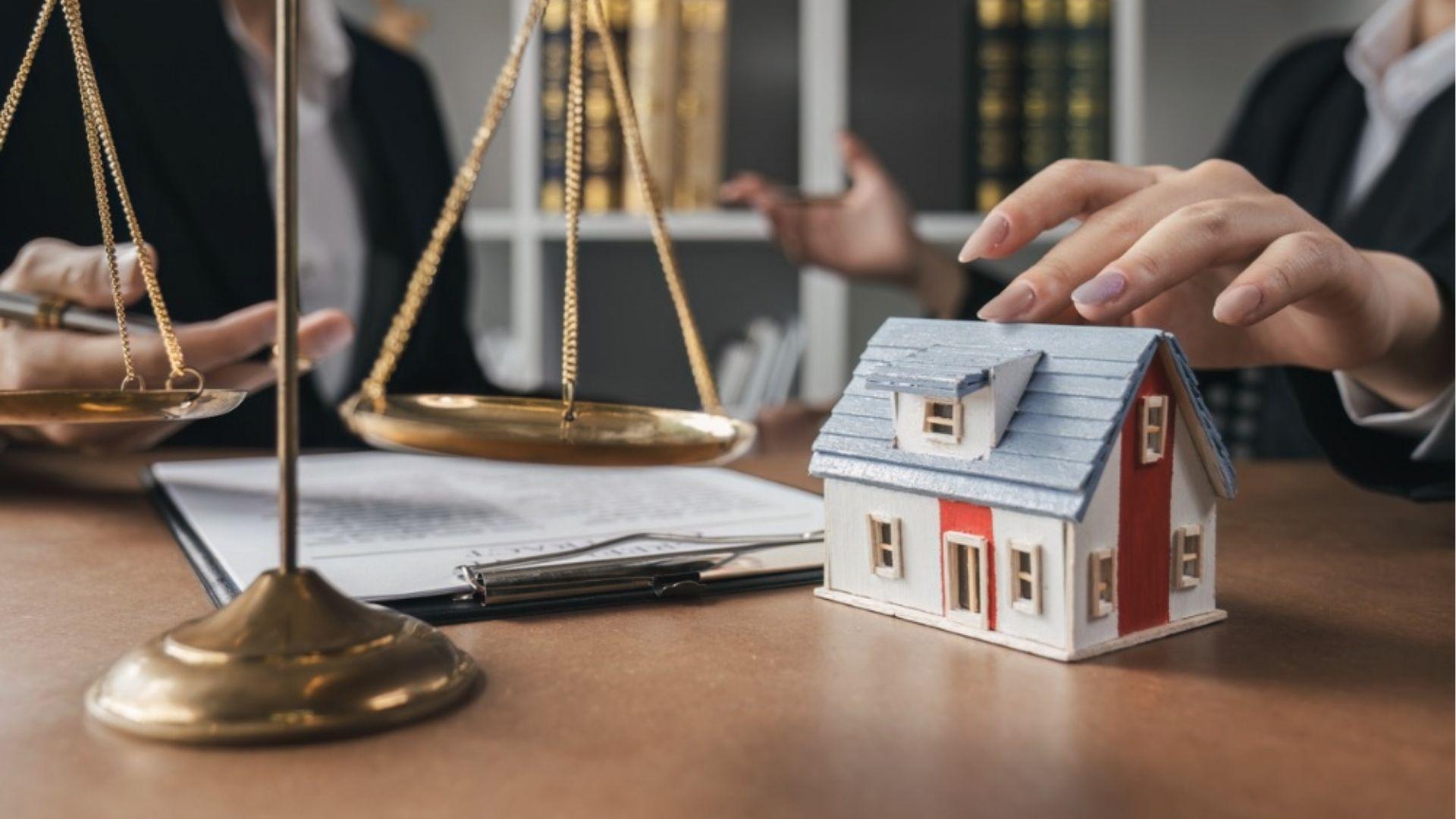 Legal scales and house model with documents showing weighing estate account vs trust account options.
