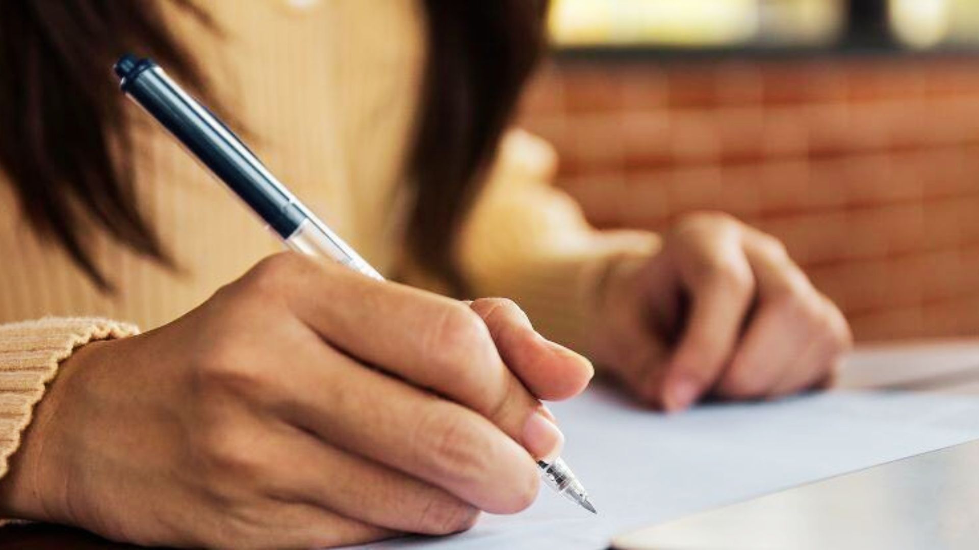 Person signing inheritance paperwork with pen, deciding on selling jointly owned property after heir agreement