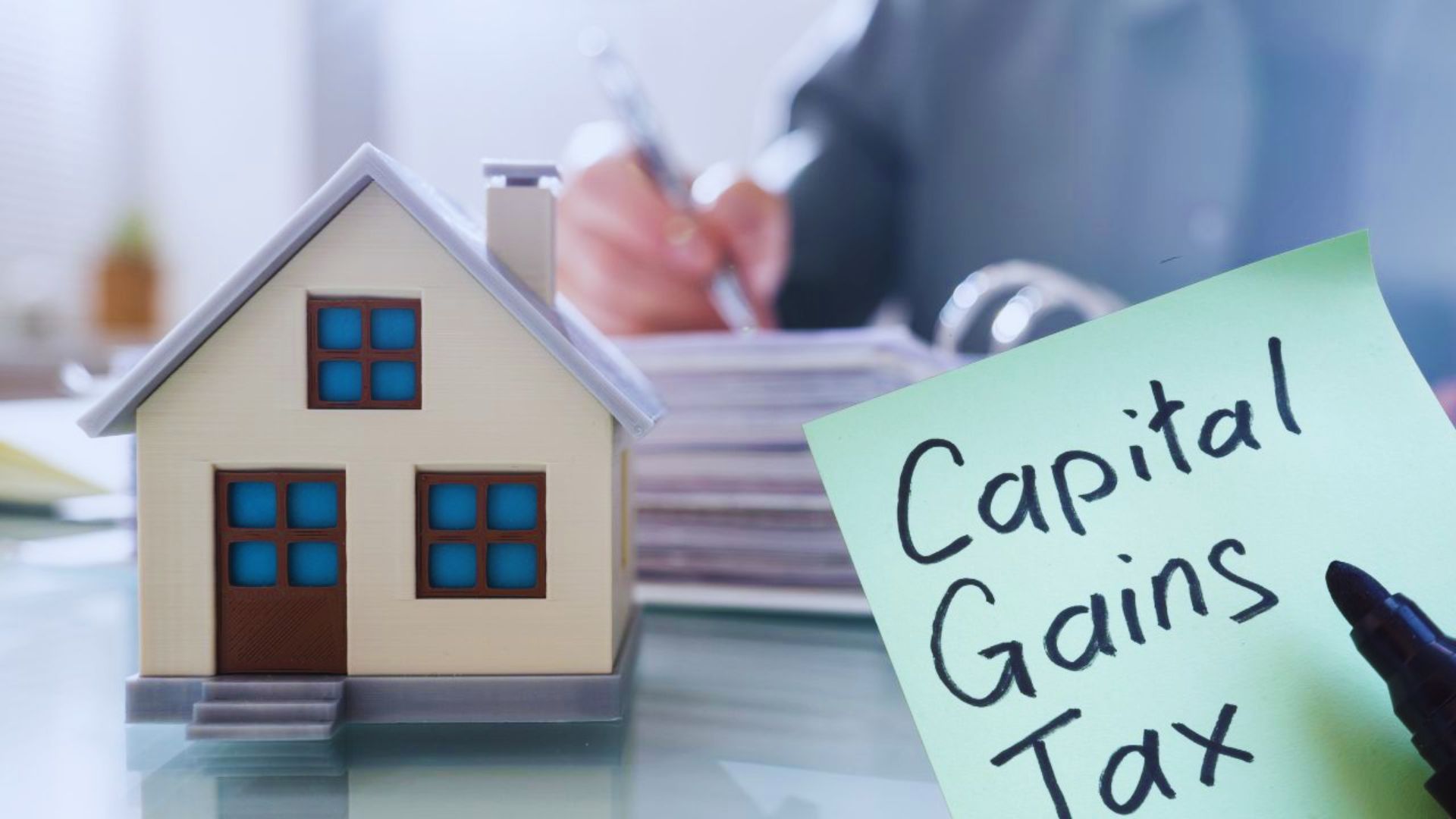 A person reviewing financial documents related to capital gains tax on inherited property.