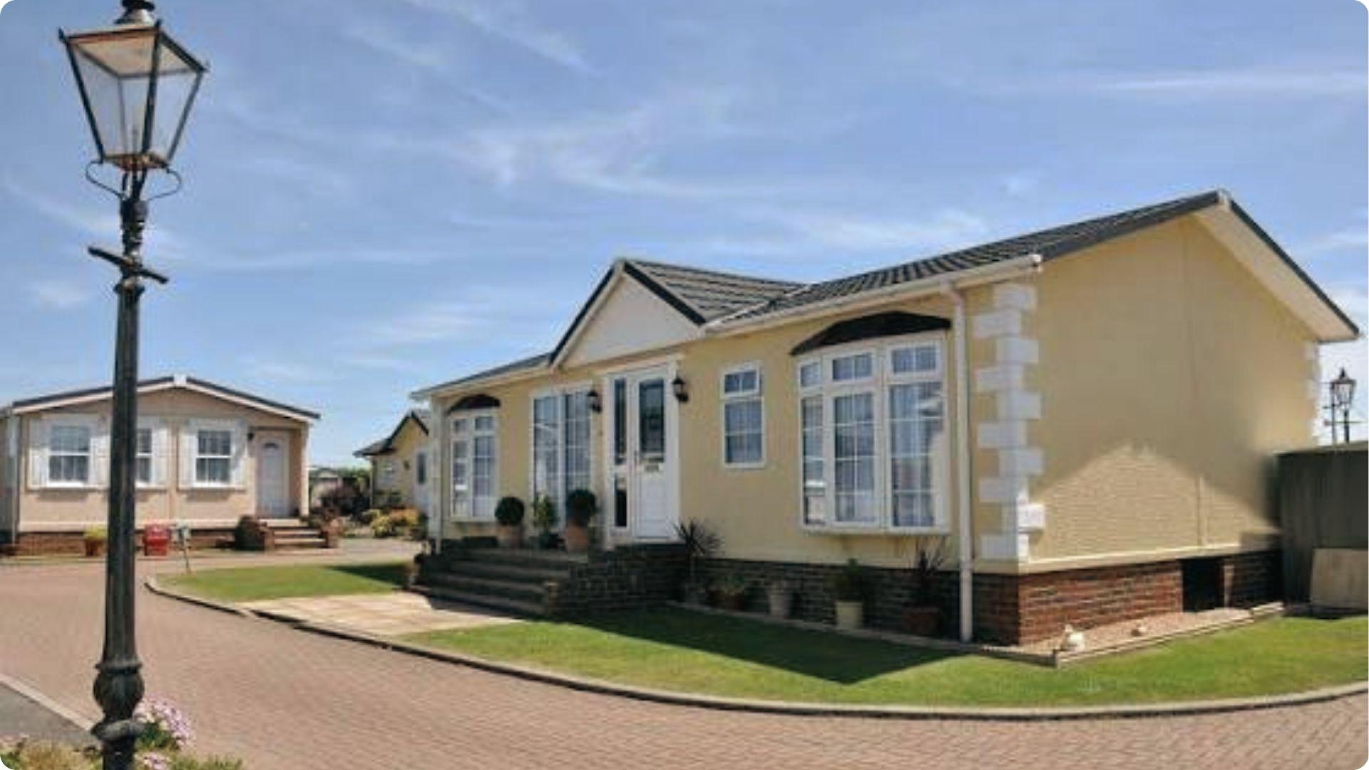 Yellow mobile home on landscaped lot showing right to maintained common areas and privacy in parks.