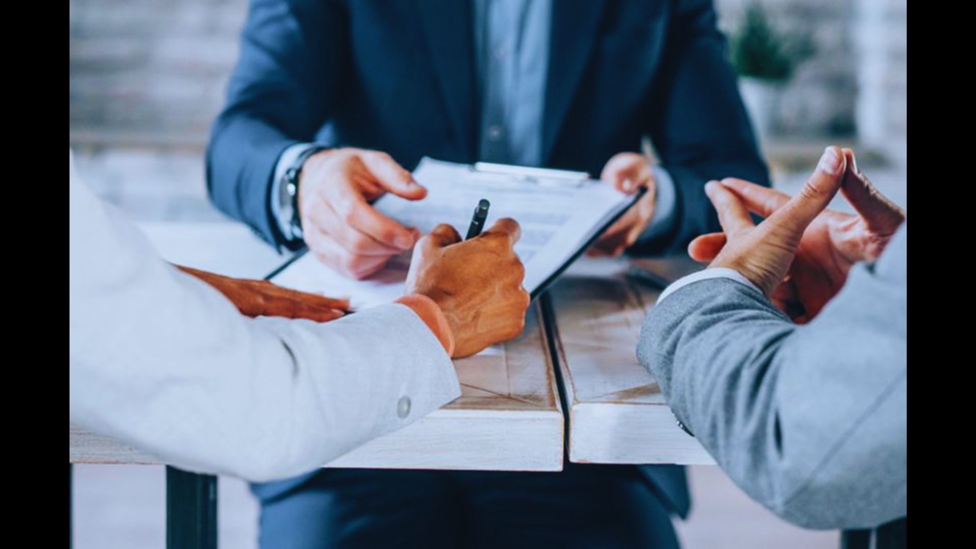 Homebuyer reviewing and signing a real estate purchase agreement.