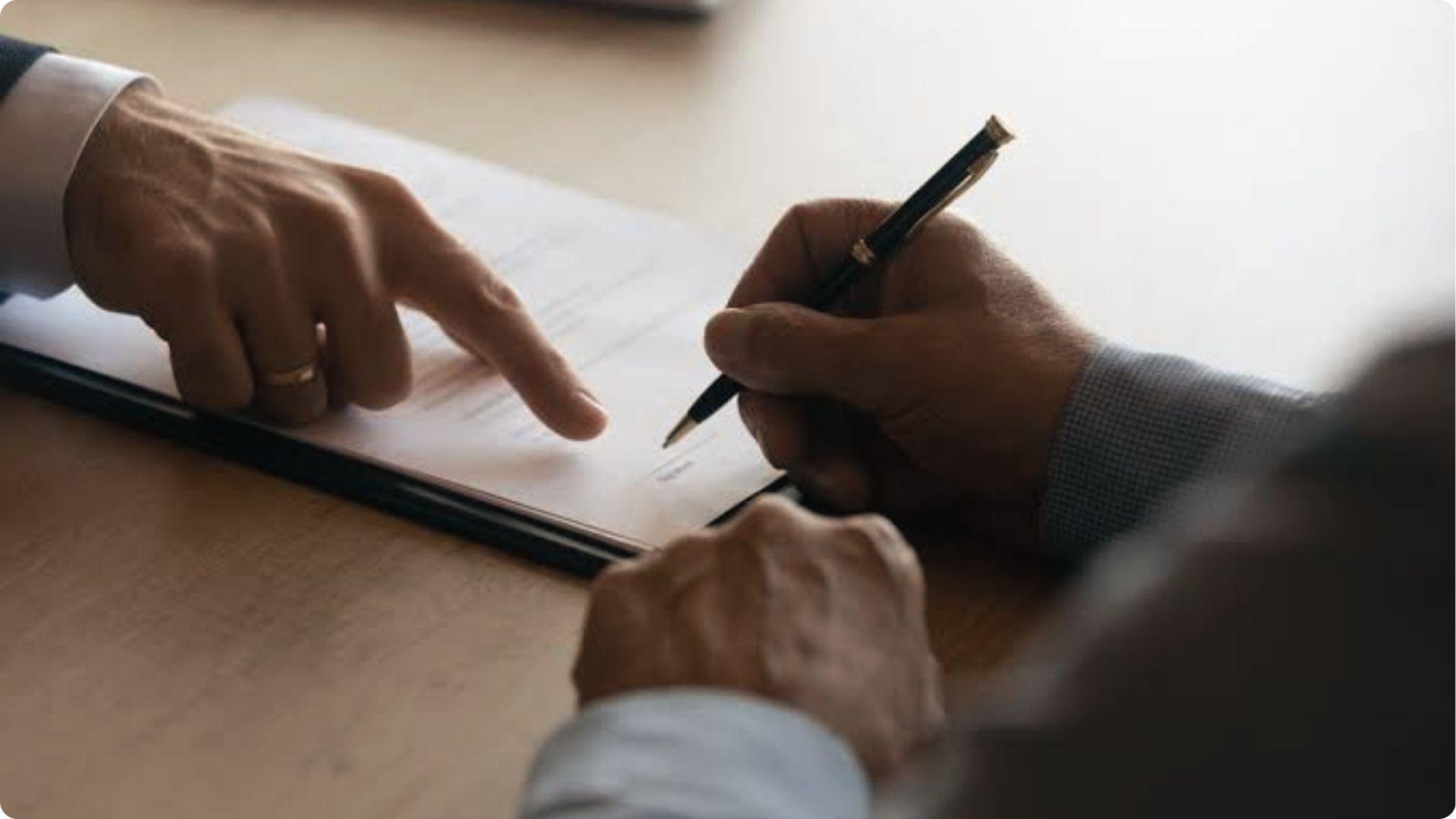 Person signing probate forms while another points, showing legal pressure when sibling refuses.