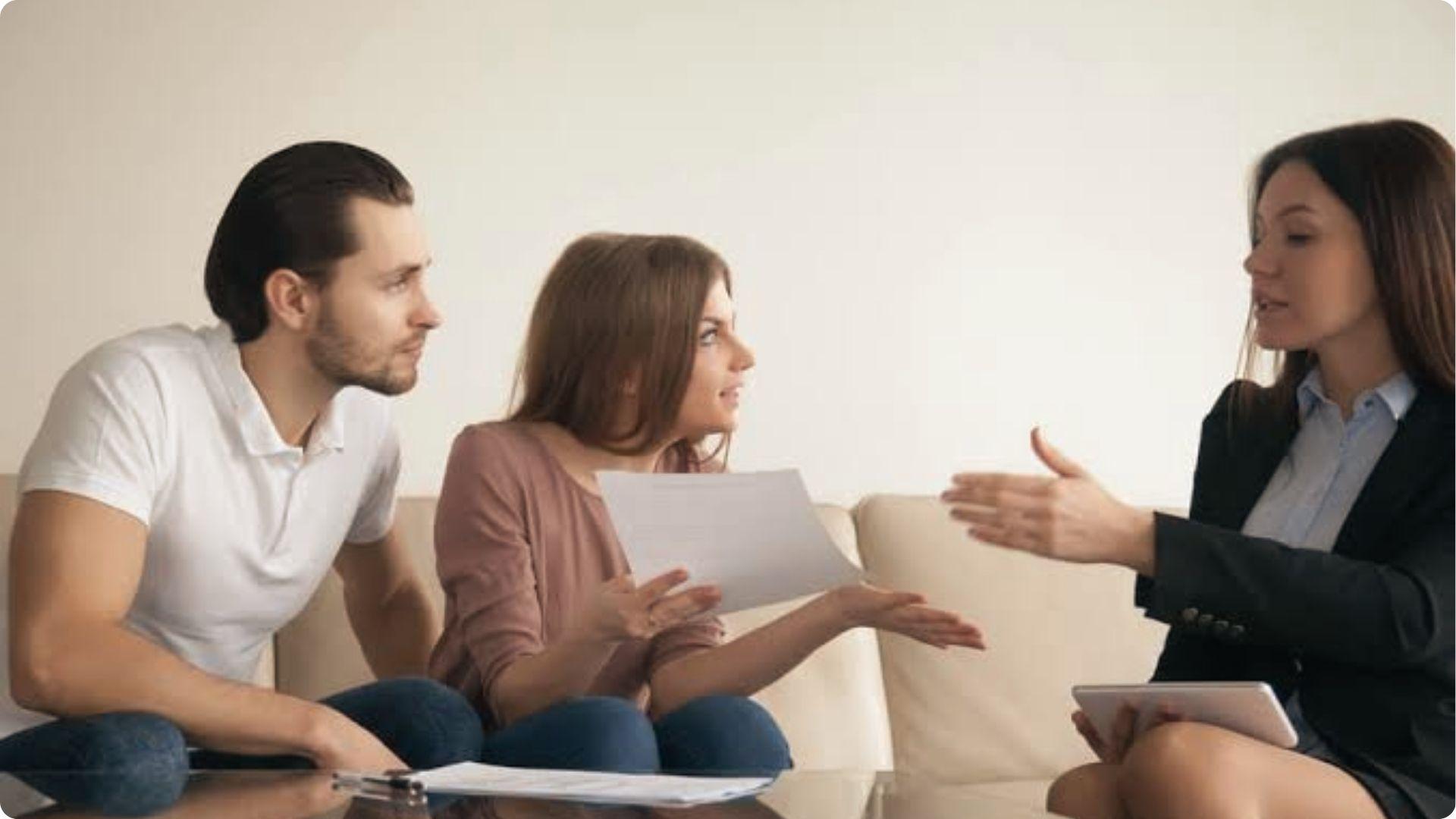 Couple discusses tenancy in common agreement issues with legal advisor reviewing property documents