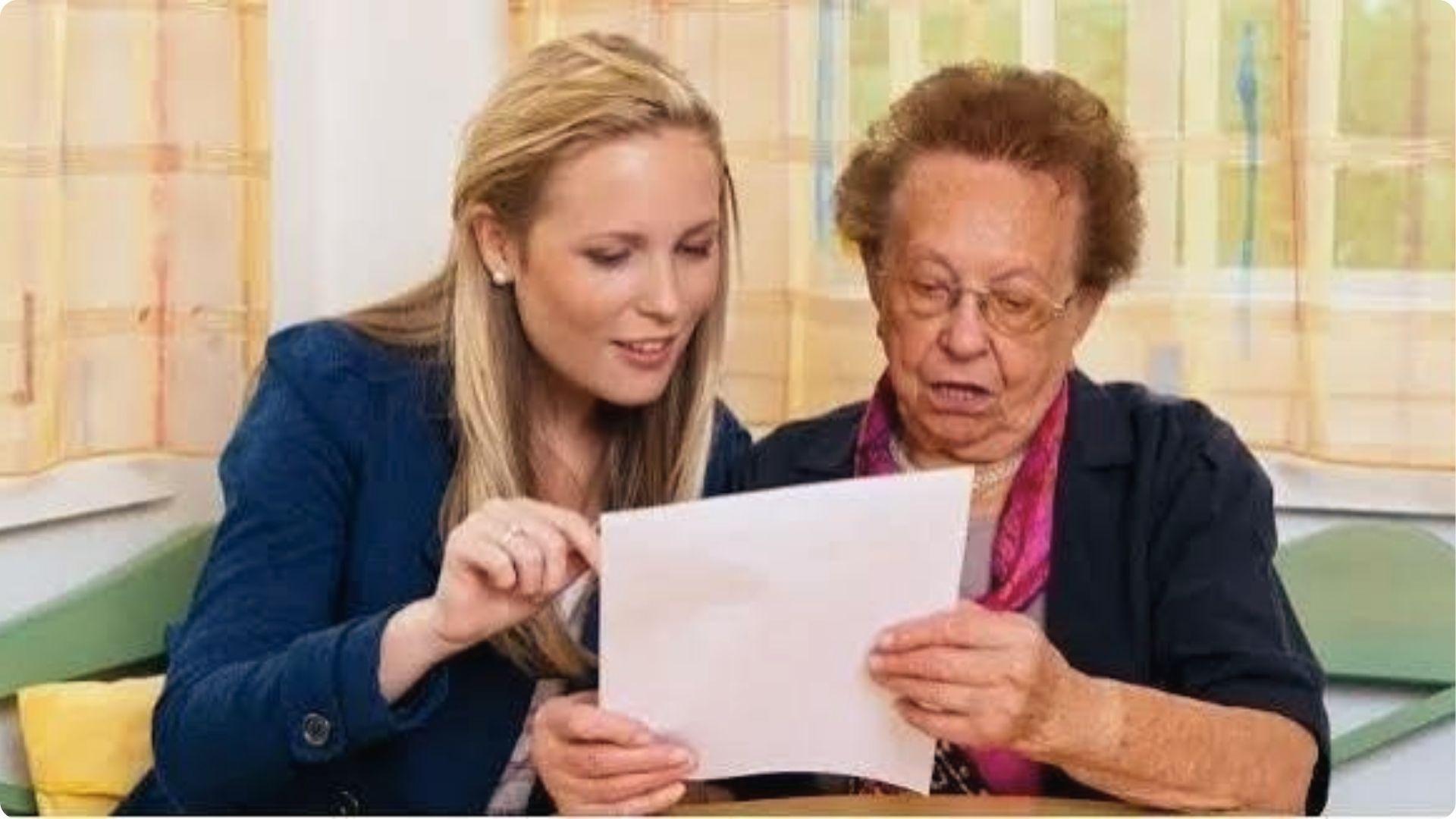 Younger woman helping senior women read legal documents for spousal property petition guidance.