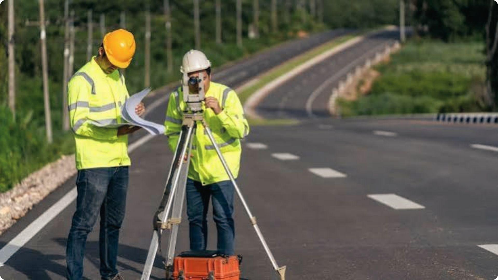 Two surveyors in safety vests survey roadside land near private property without owner permission