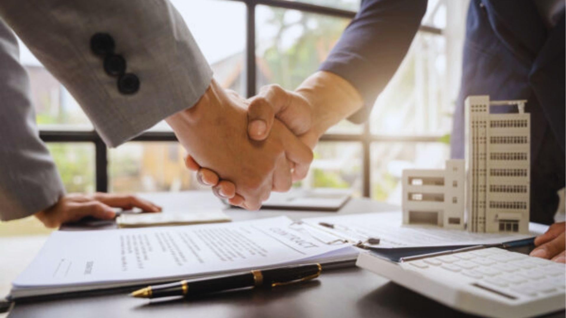 Two people signing a house contract
