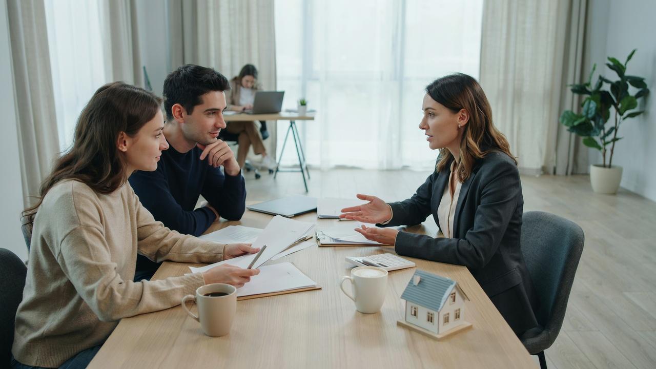 Homebuyer reviewing closing documents and financing options with a mortgage professional.