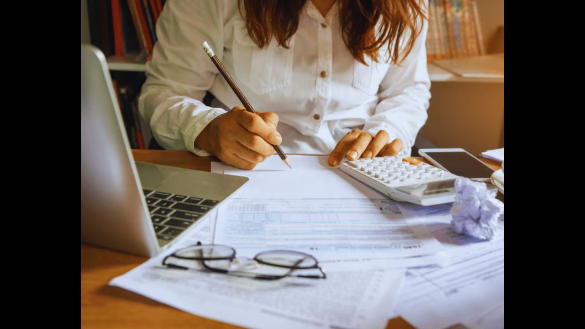 Homebuyer calculating costs before completing a home purchase.