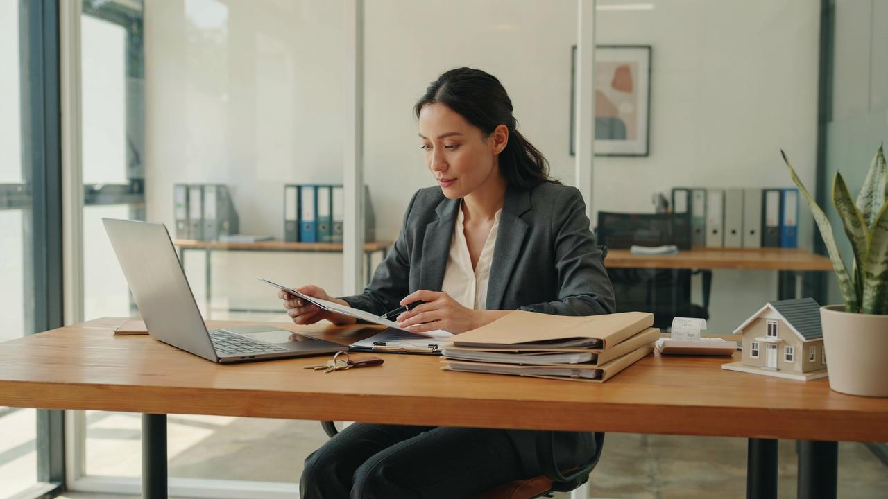 Property manager organizing lease records and communicating with tenants to manage rental properties efficiently.