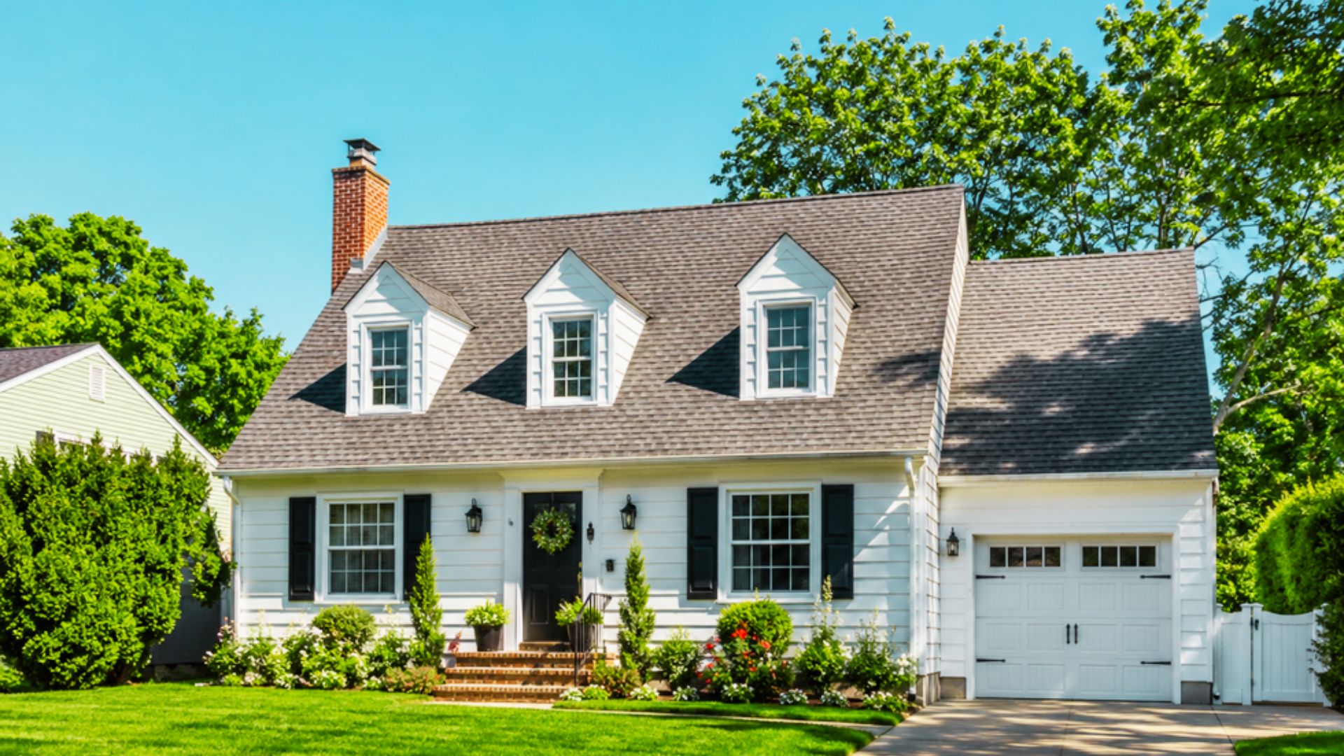 A white house with a black roof and white trim, representing inherited property in a discussion about capital gains tax.