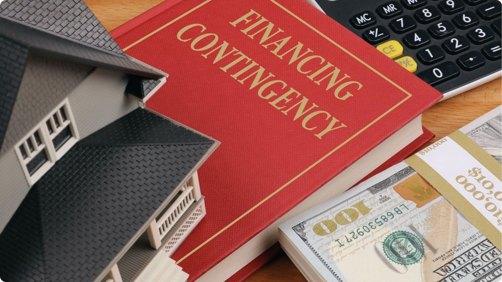 Model house next to red book titled Financing Contingency with calculator and $10,000 cash bundle.