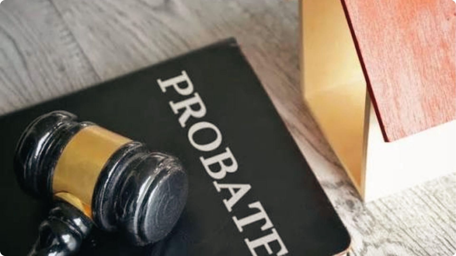 Gavel on probate law book next to house model symbolizing sibling dispute over estate property.