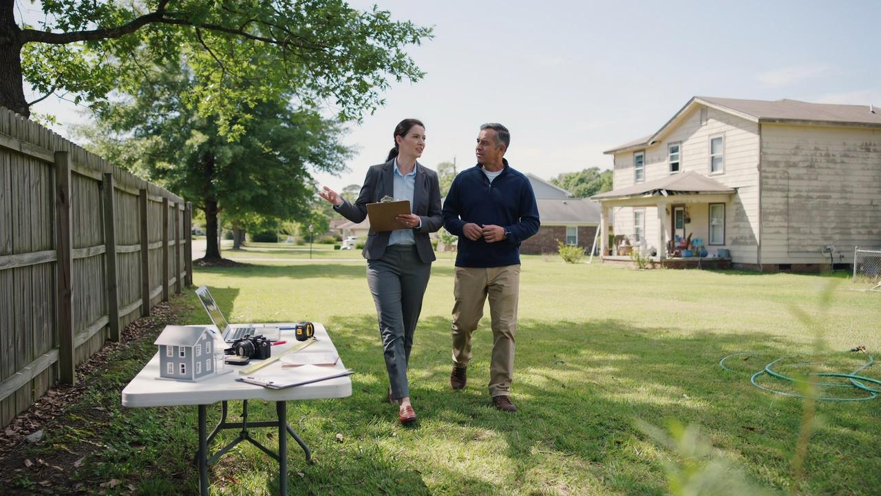 Property owner and attorney inspecting a residential property while evaluating evidence of long-term occupancy.
