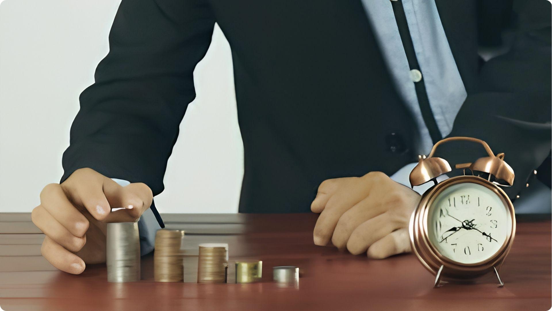 Person stacking coins by alarm clock showing financial timing for exempt property in eminent domain