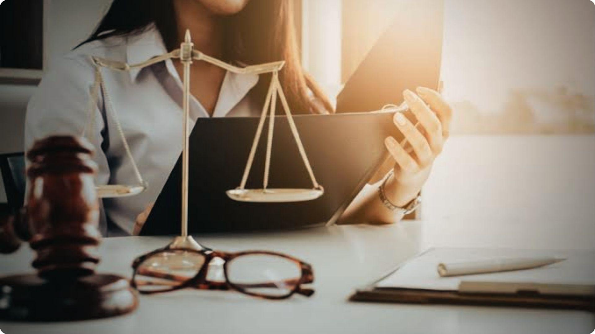 Lawyer reviews holdover tenant case with justice scales and gavel on desk for legal advice
