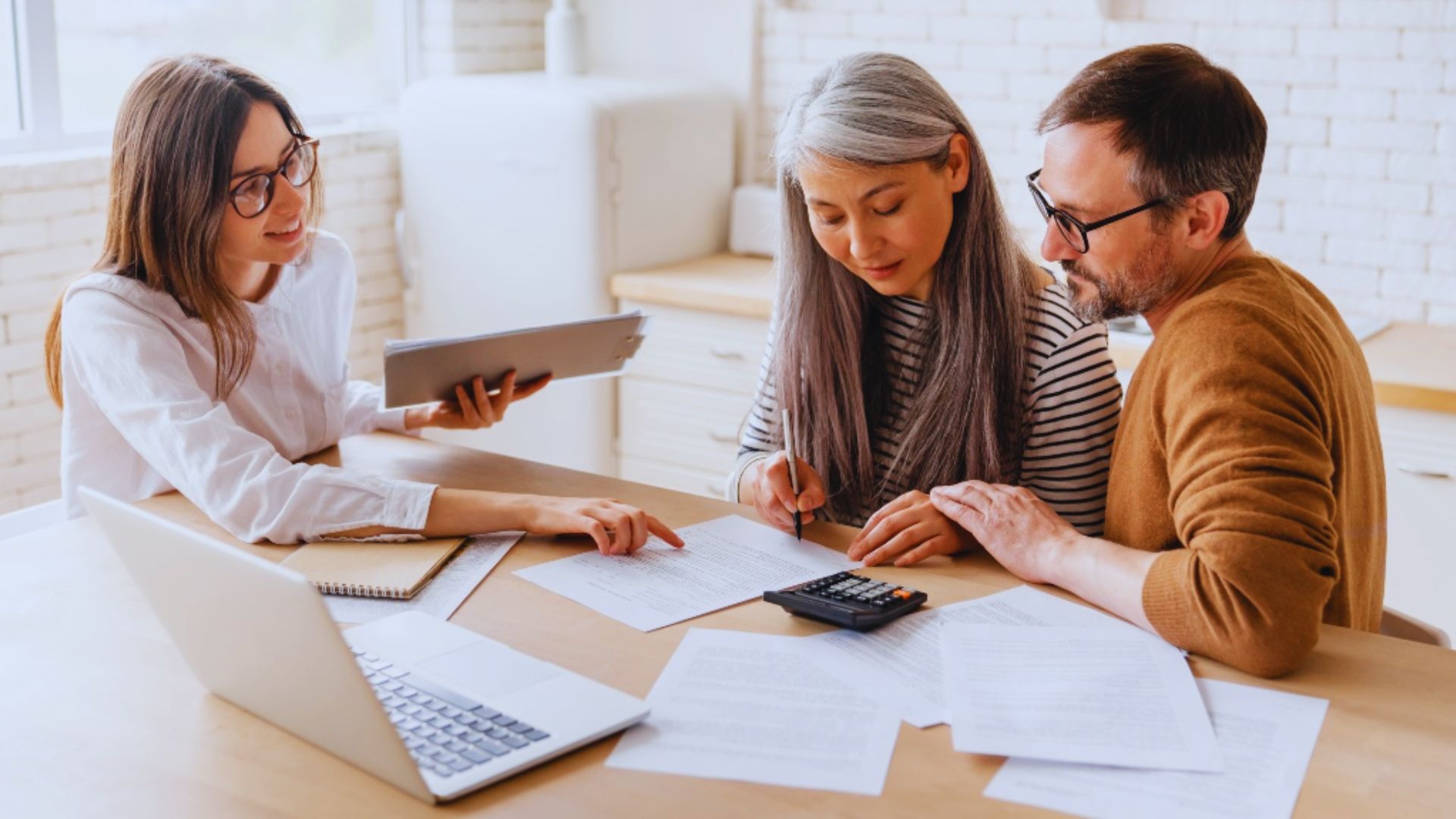 Attorney explaining estate planning documents to a couple during a legal consultation.