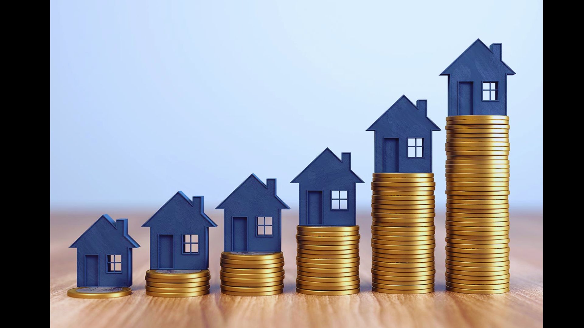 Blue model houses sitting on growing stacks of gold coins.