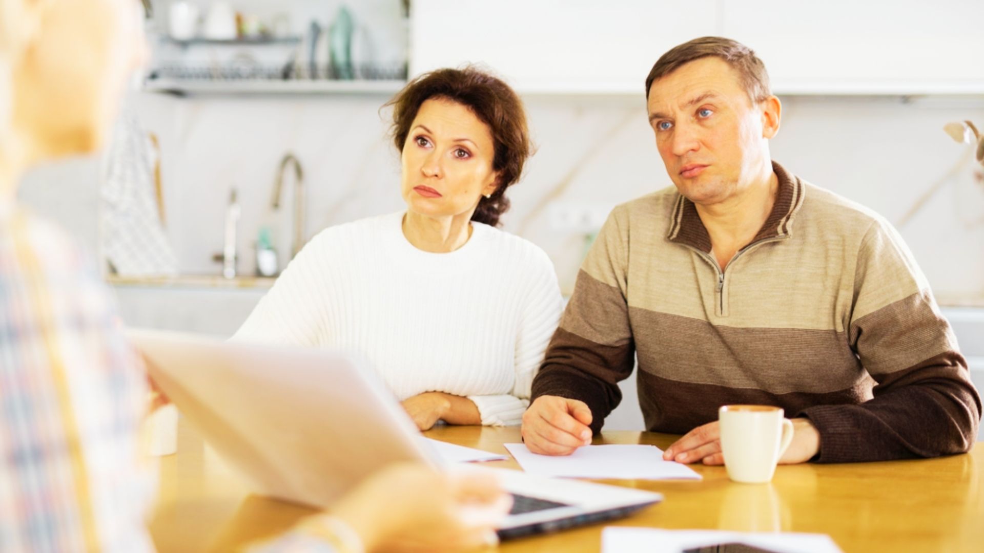 A couple analyzing documents related to an irrevocable trust for financial planning.