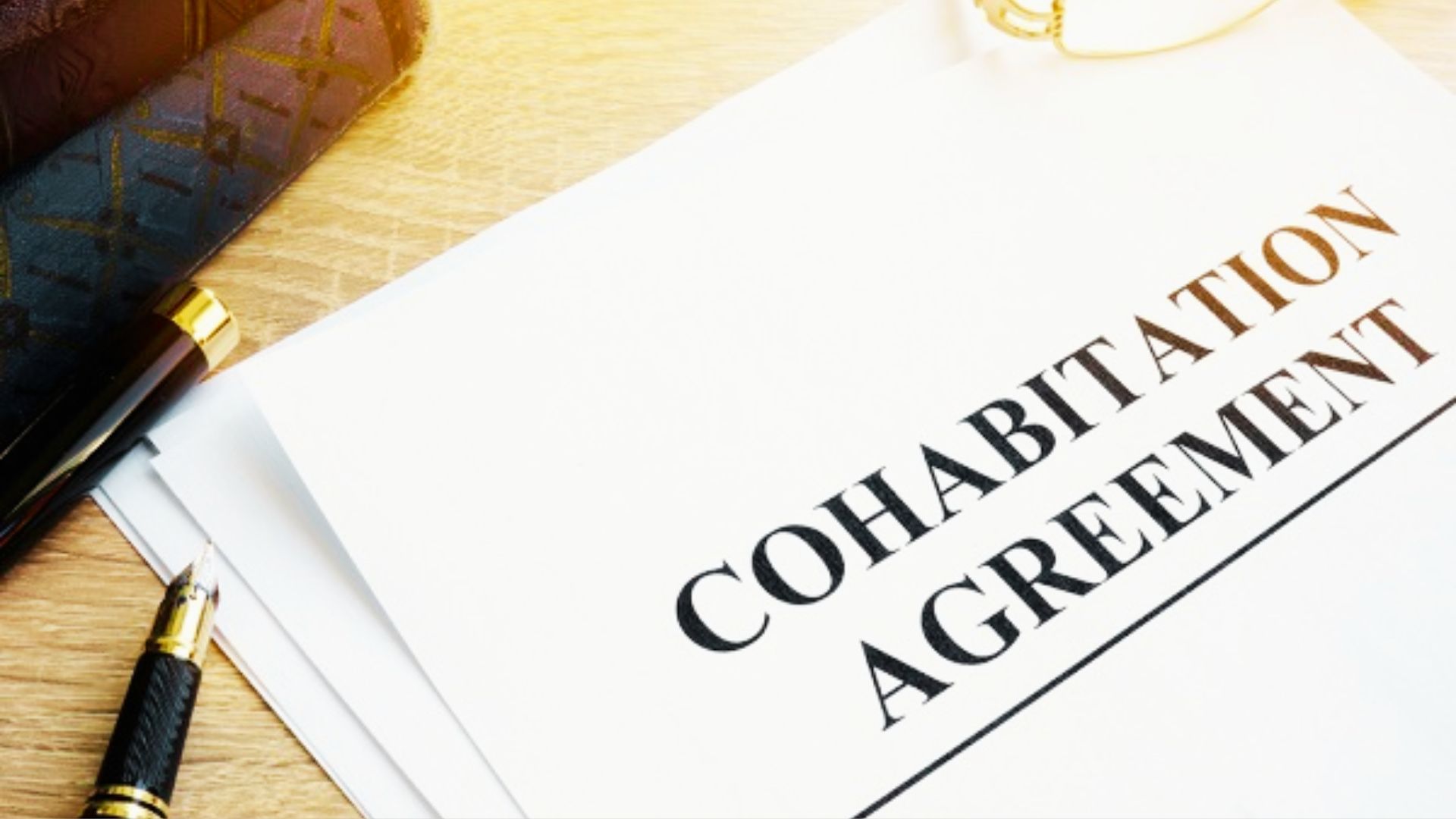 cohabitation agreement document placed on a desk, outlining property rights for unmarried couples.