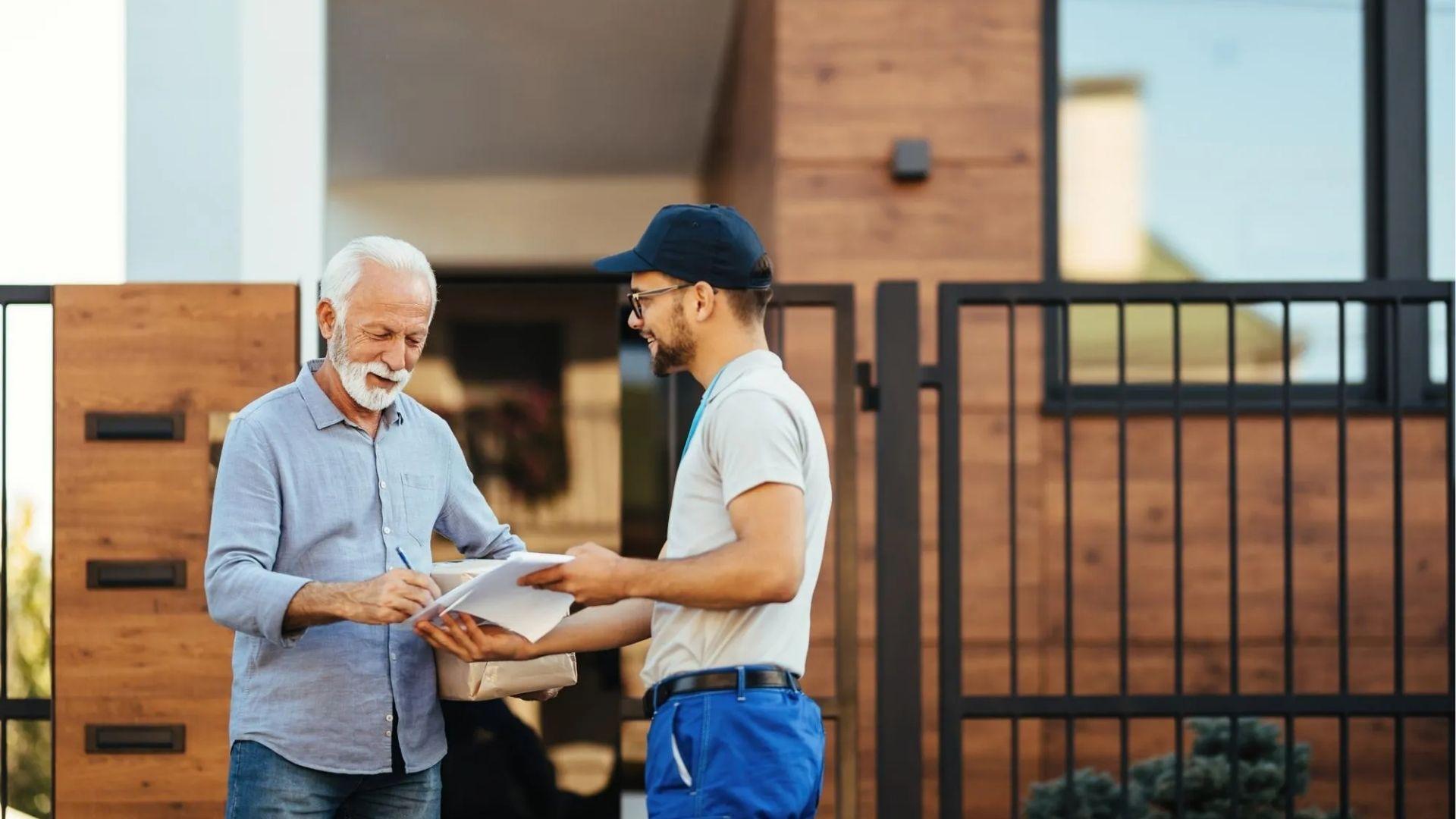 Older man signing important paperwork at his gate