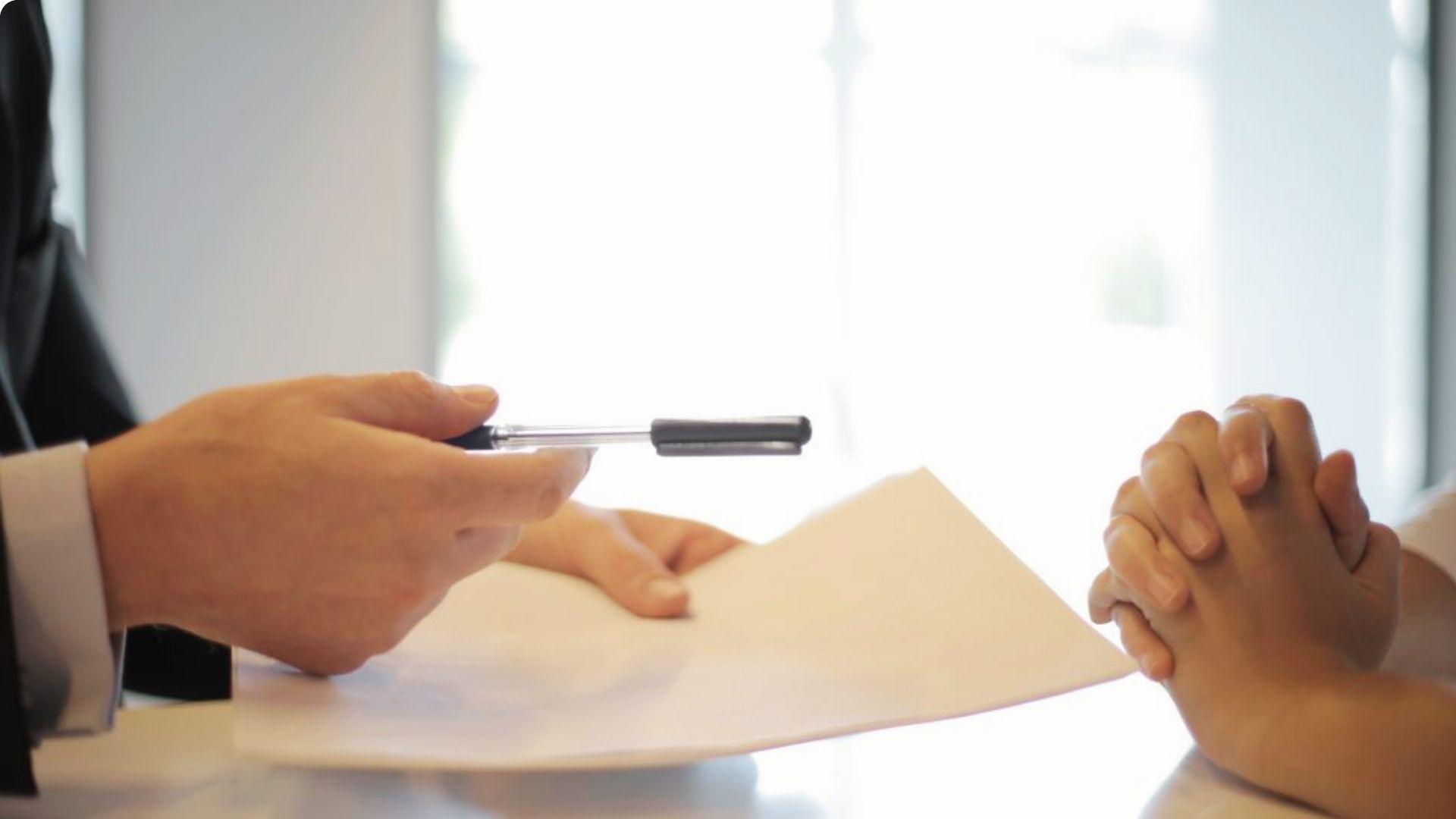 Two people discussing warranty deed Proof of ownership with pen and document