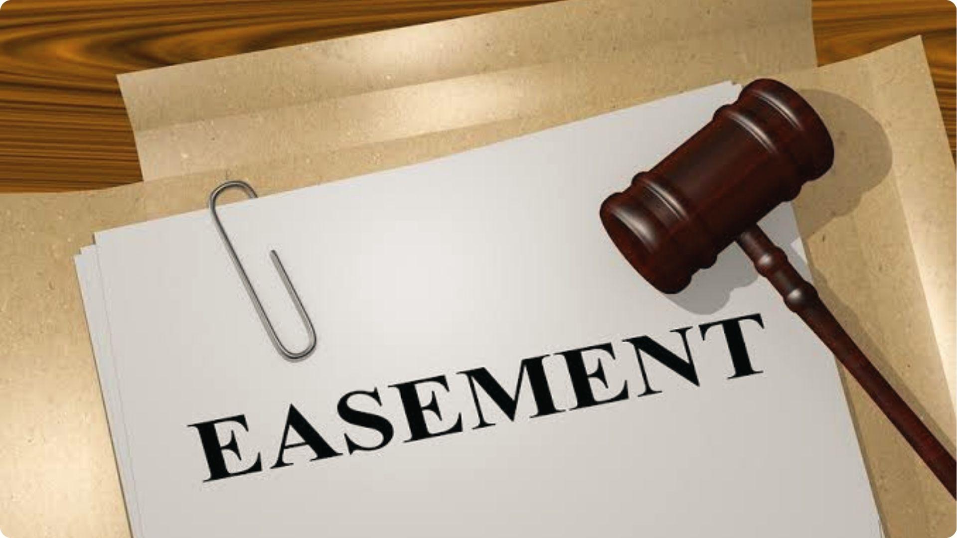 Legal document marked EASEMENT with judge gavel on desk representing property access rights law