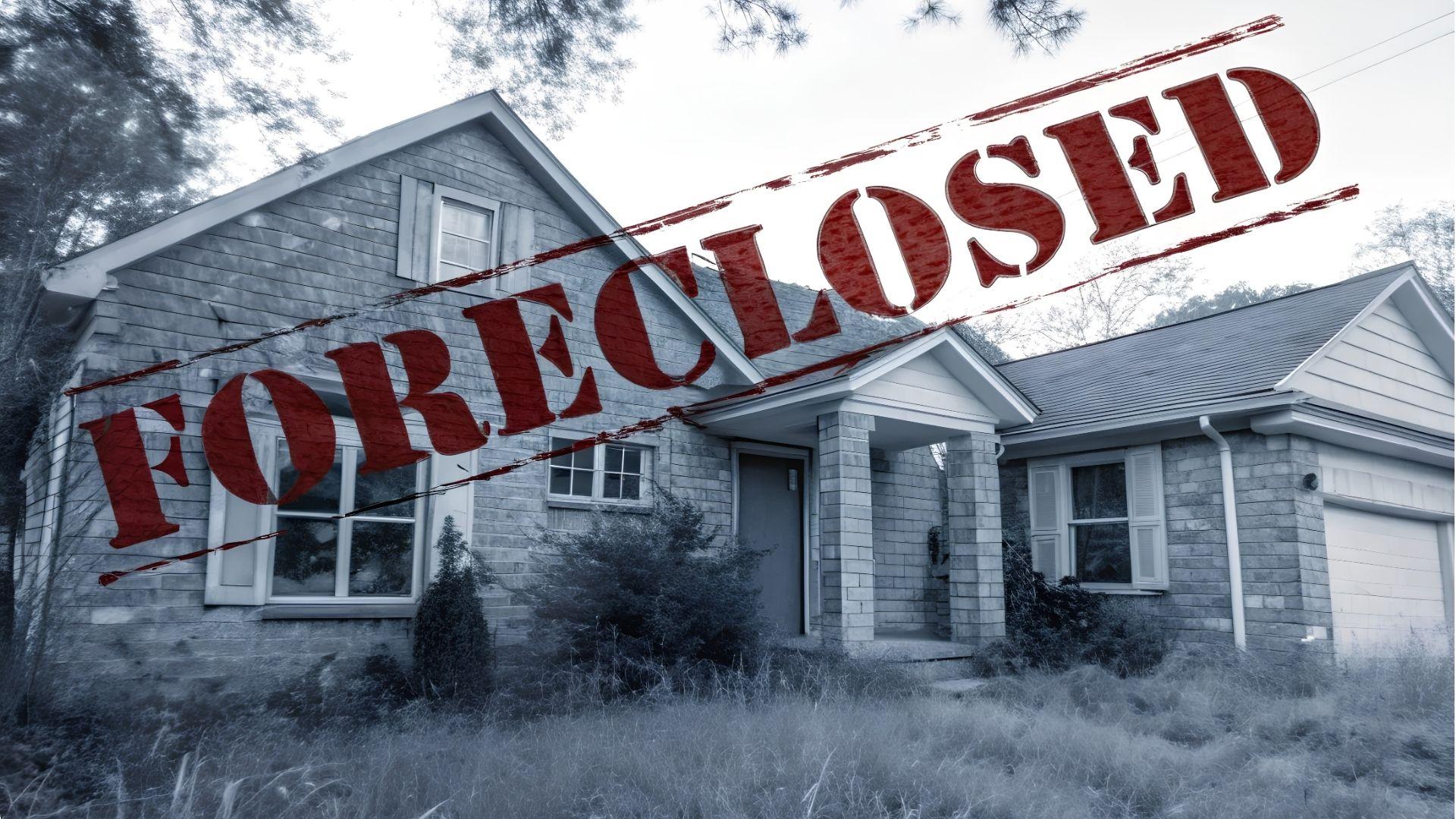 Weathered suburban house with bold red FORECLOSED stamp across the image