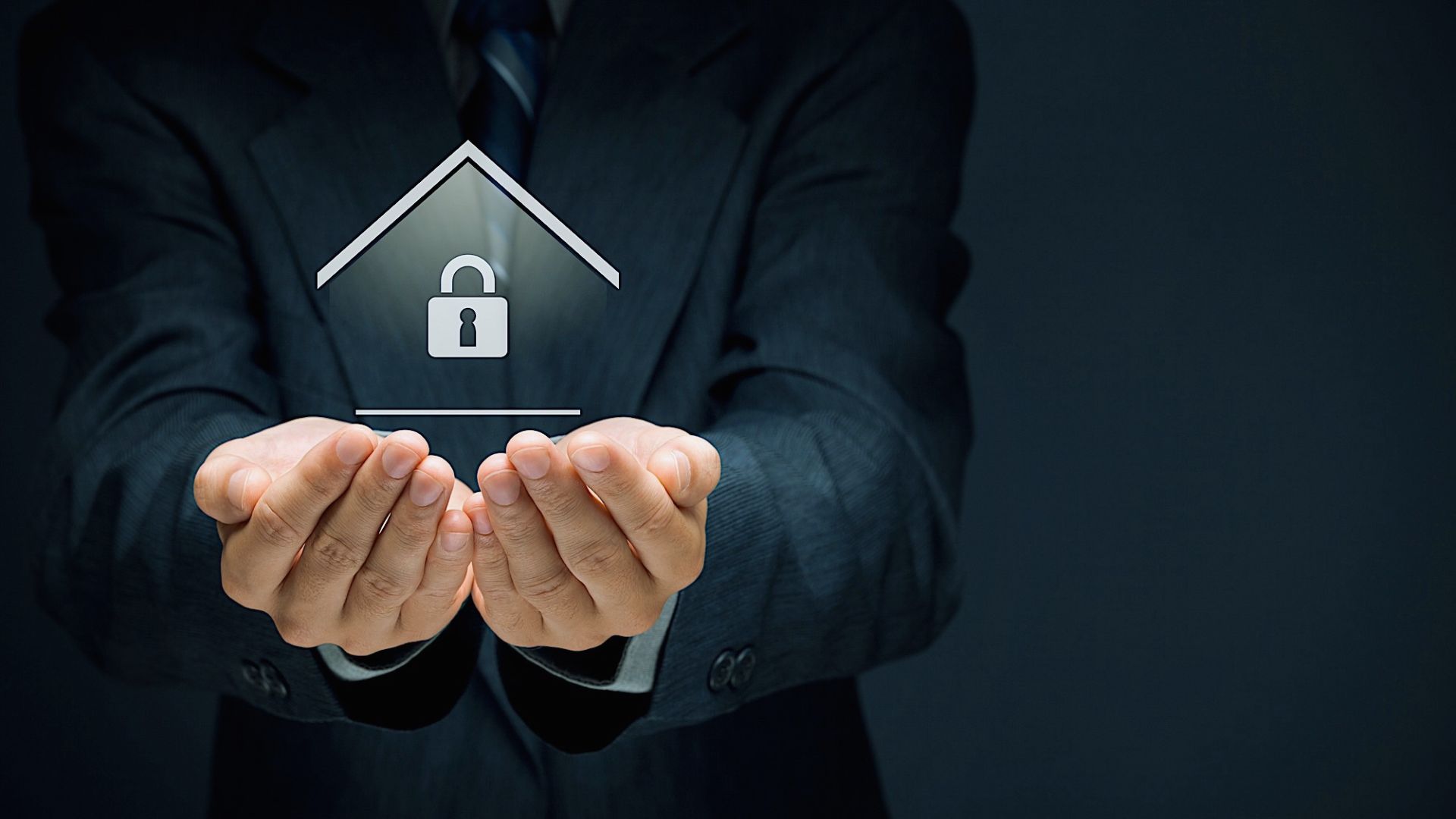Businessman holding secure home concept with digital house and padlock icon, mortgage protection