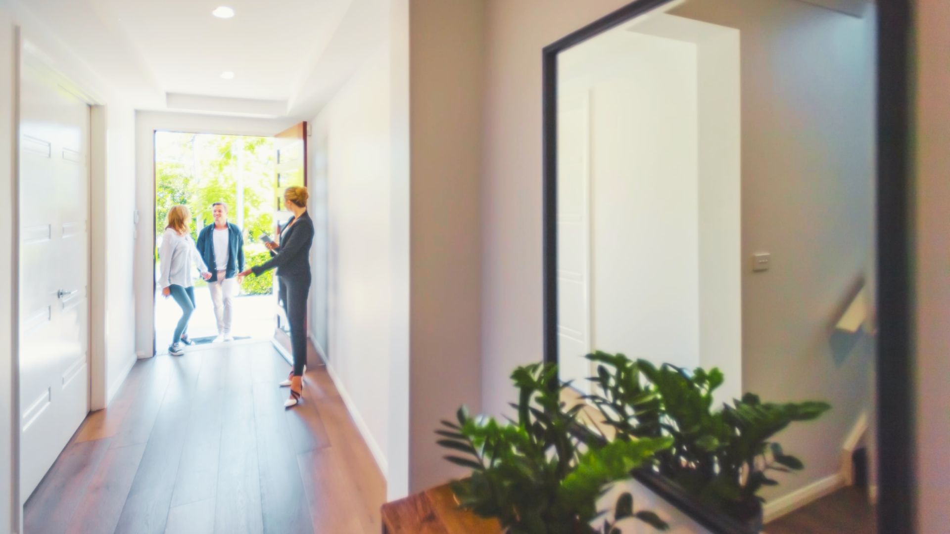 a broker showing a house to an unmarried couple.