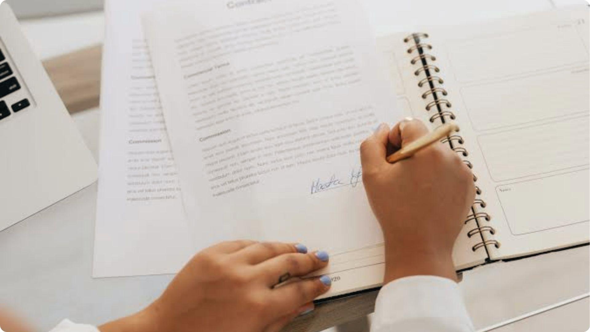 Executor signs contracts for personal gain, closeup of hand signing commission agreement papers.