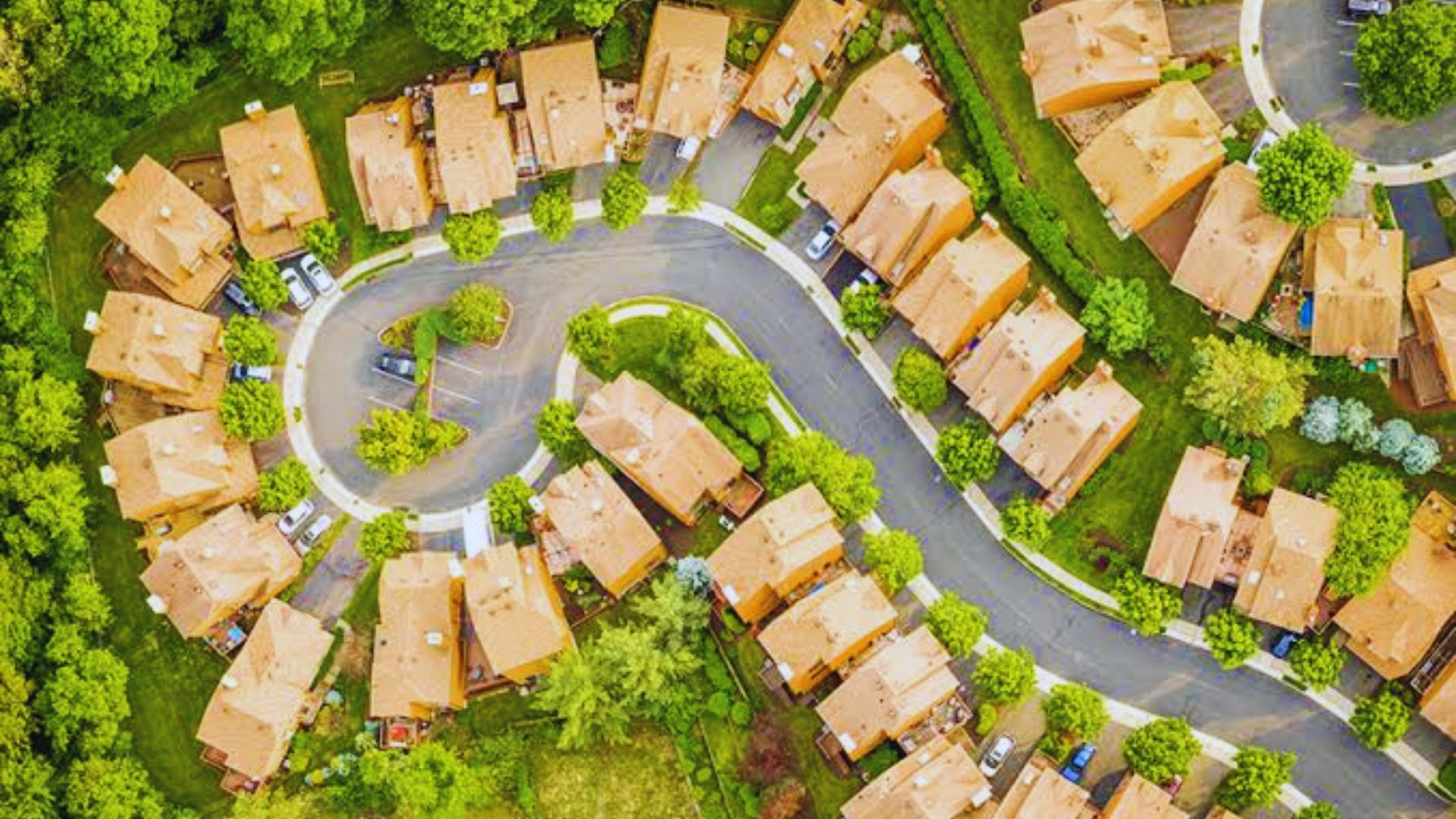 Aerial view of a suburban residential neighborhood showcasing houses and green spaces.