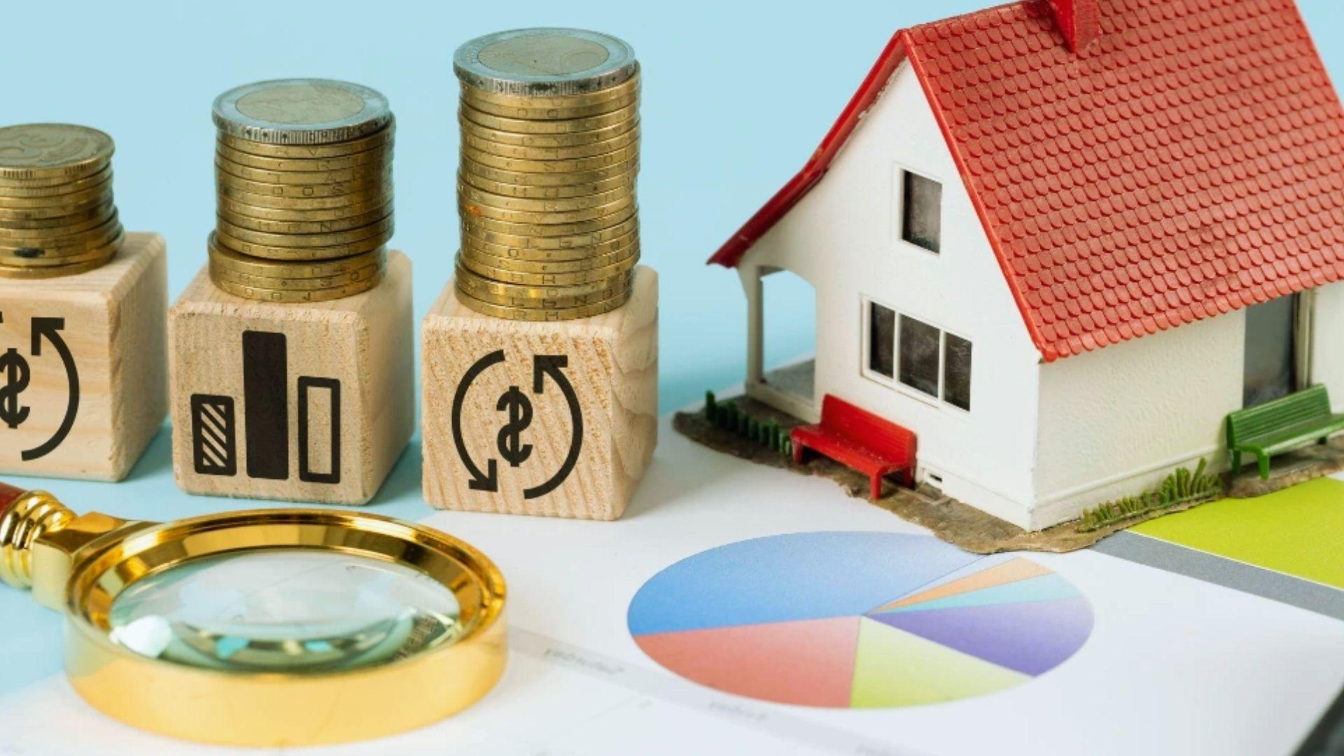 Model house with coin stacks on finance blocks, magnifying glass and pie chart