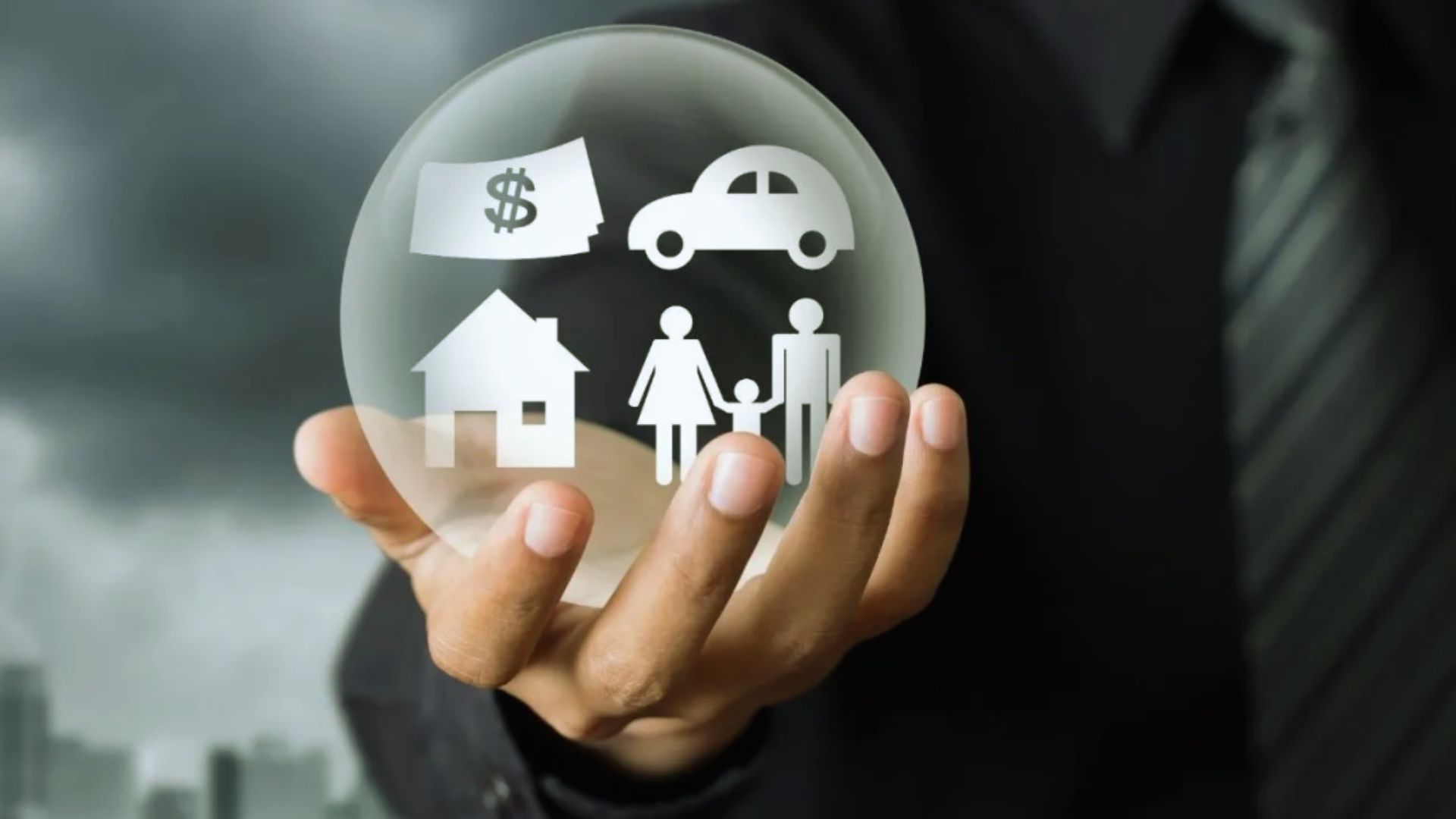 Family asset protection insurance concept with crystal ball showing home, car, money and family icons