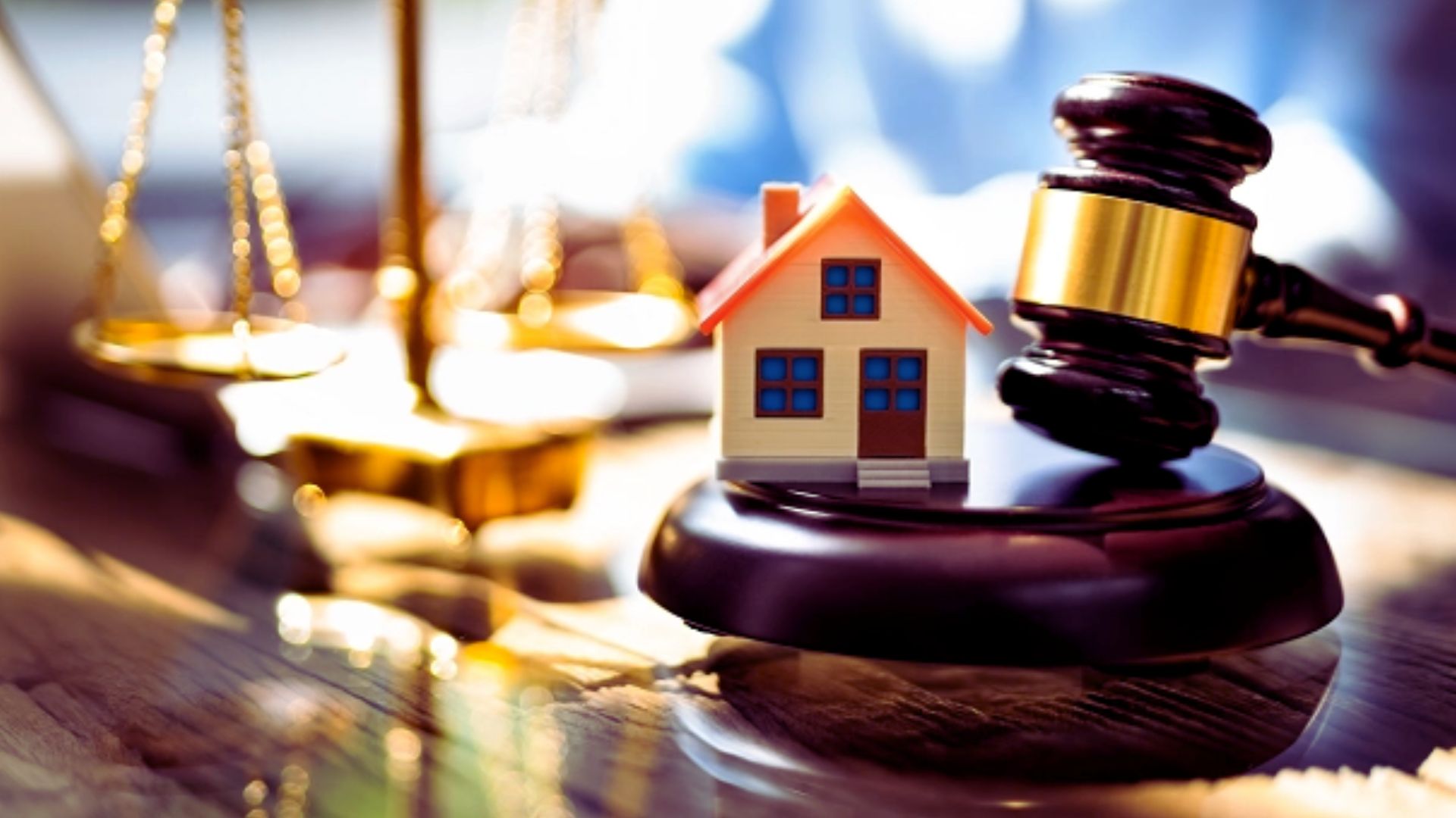 Real estate law and property auction concept with judge gavel, house model, and justice scale on desk