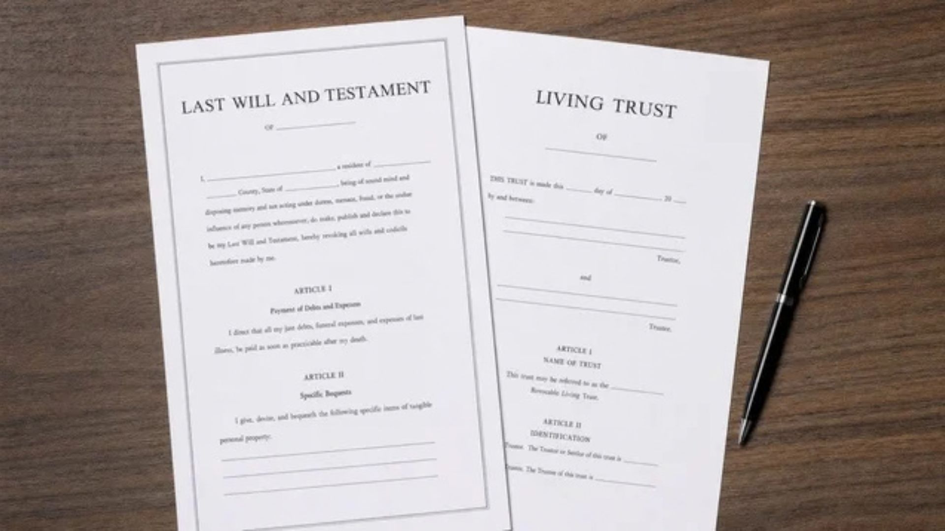 Will and trust documents beside a pen on a desk